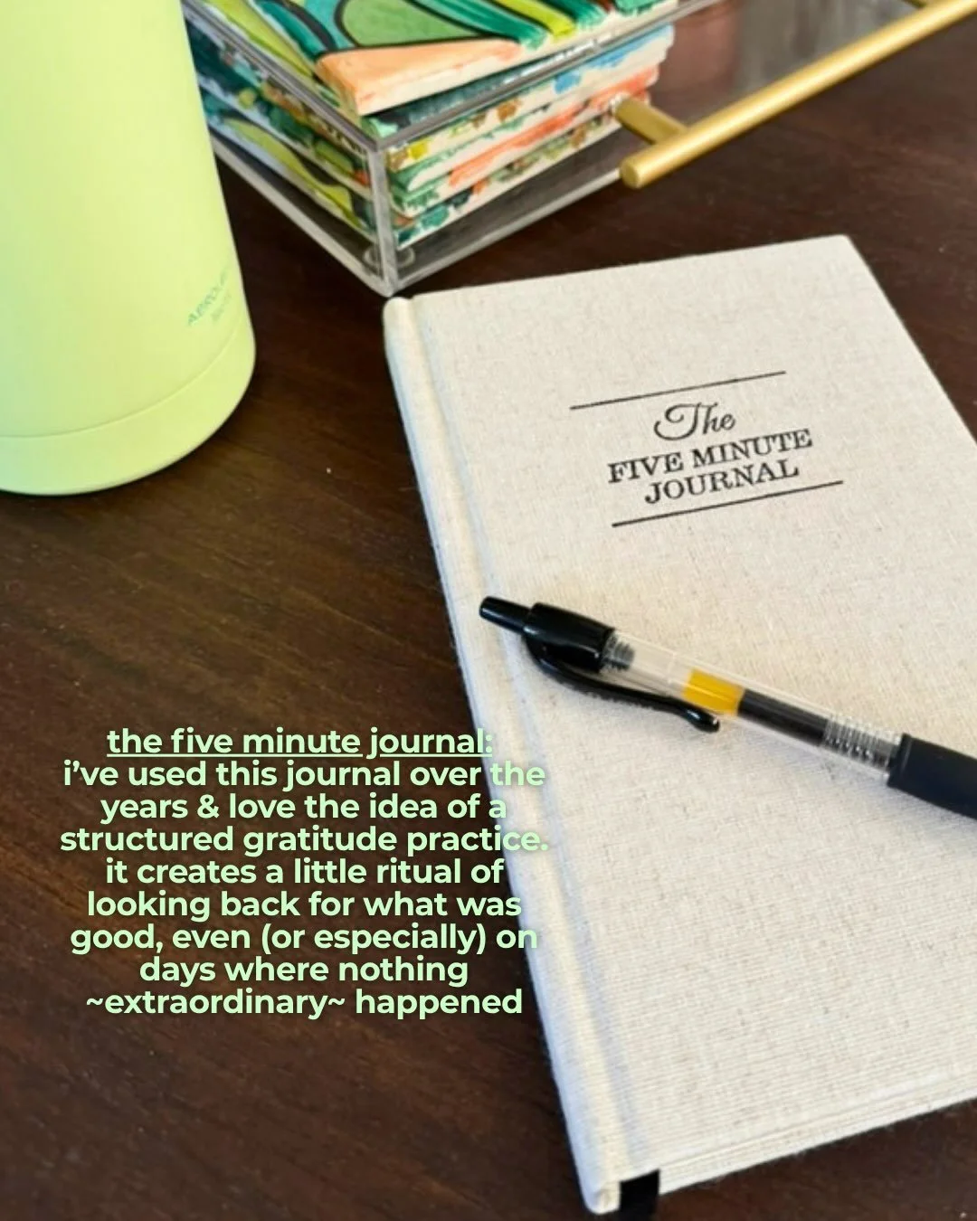 The Five Minute Journal with a pen resting on top