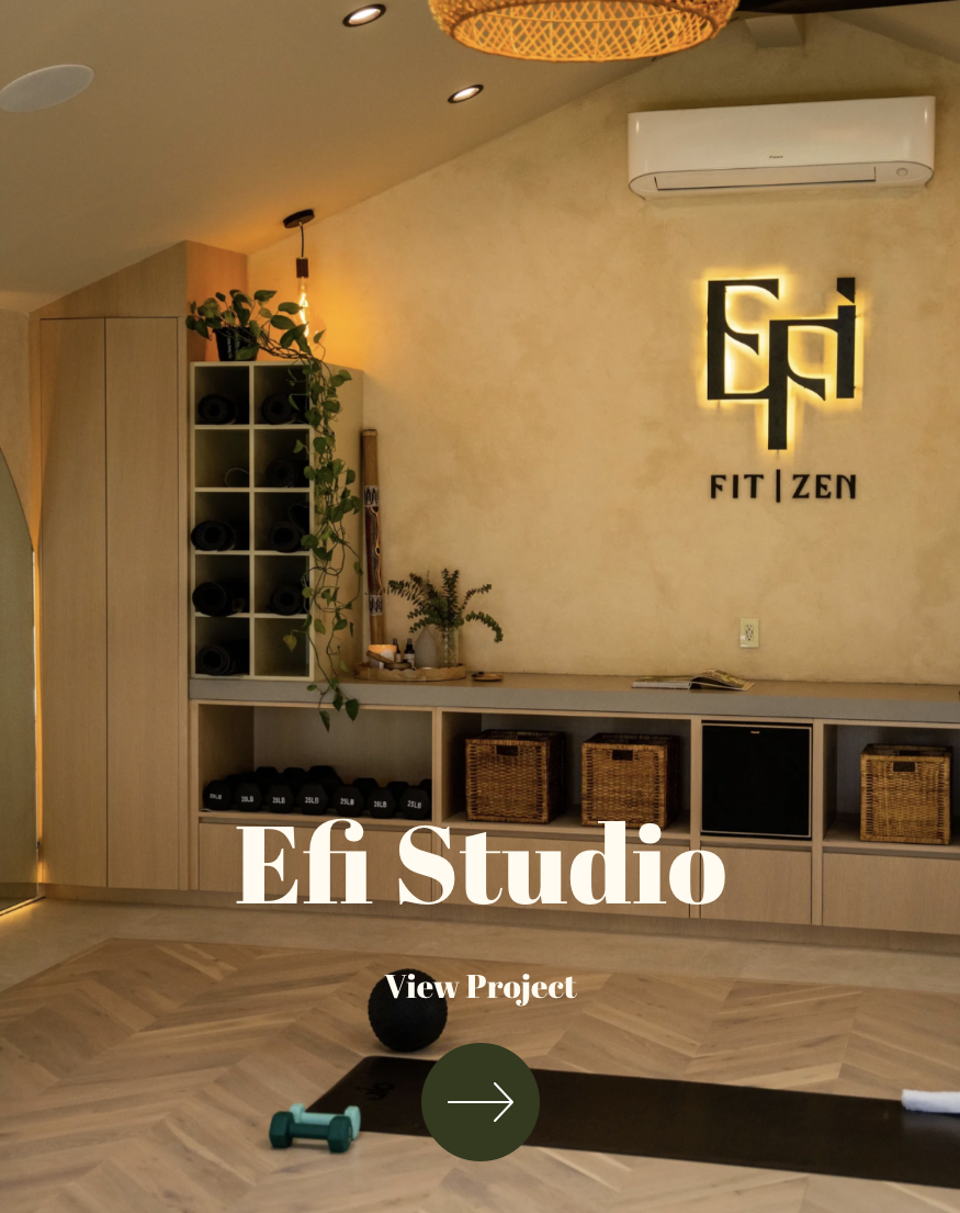 Yoga studio reception area with shelves of rolled mats, potted plants, and wicker baskets, illuminated with warm lighting and a sign that reads 'FIT | ZEN'.