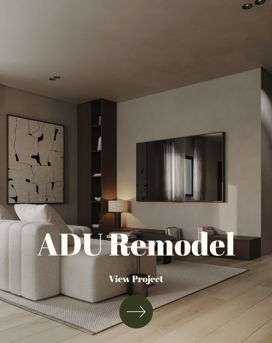 Living room with beige sofa, modern artwork on the wall, a large mirror, a side lamp, and a built-in shelving unit in a renovated sleek home interior.
