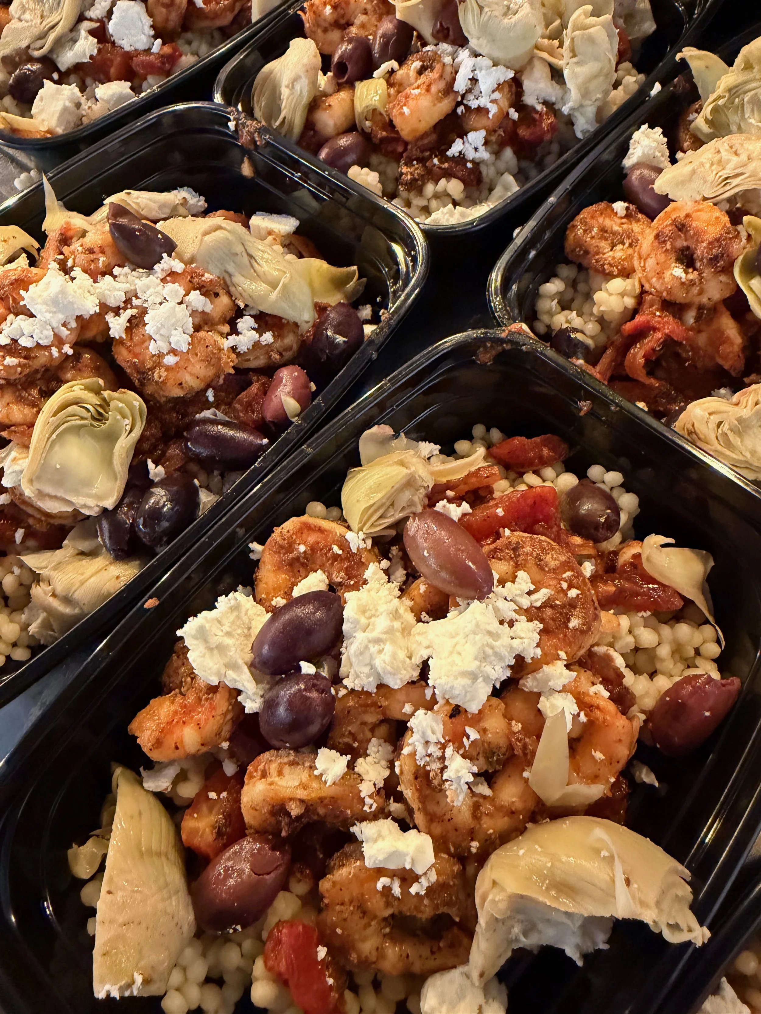 mediterranean shrimp meal with couscous olives and feta