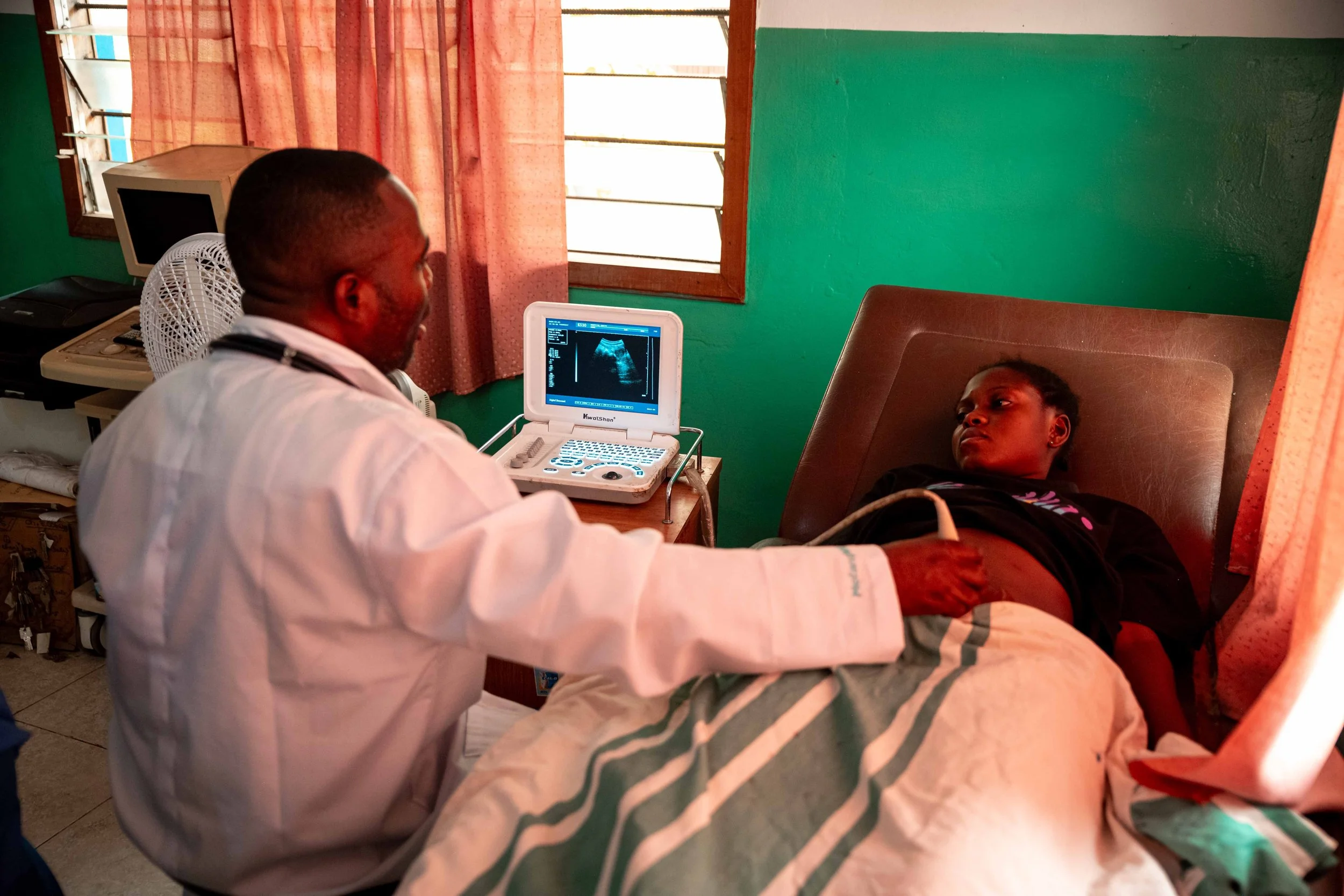 Doctor Grace Pumu,performs an ultrasound made possible thanks to solar power at the Paganoni health center, in Kwilu, Democratic Republic of Congo, September 2025.