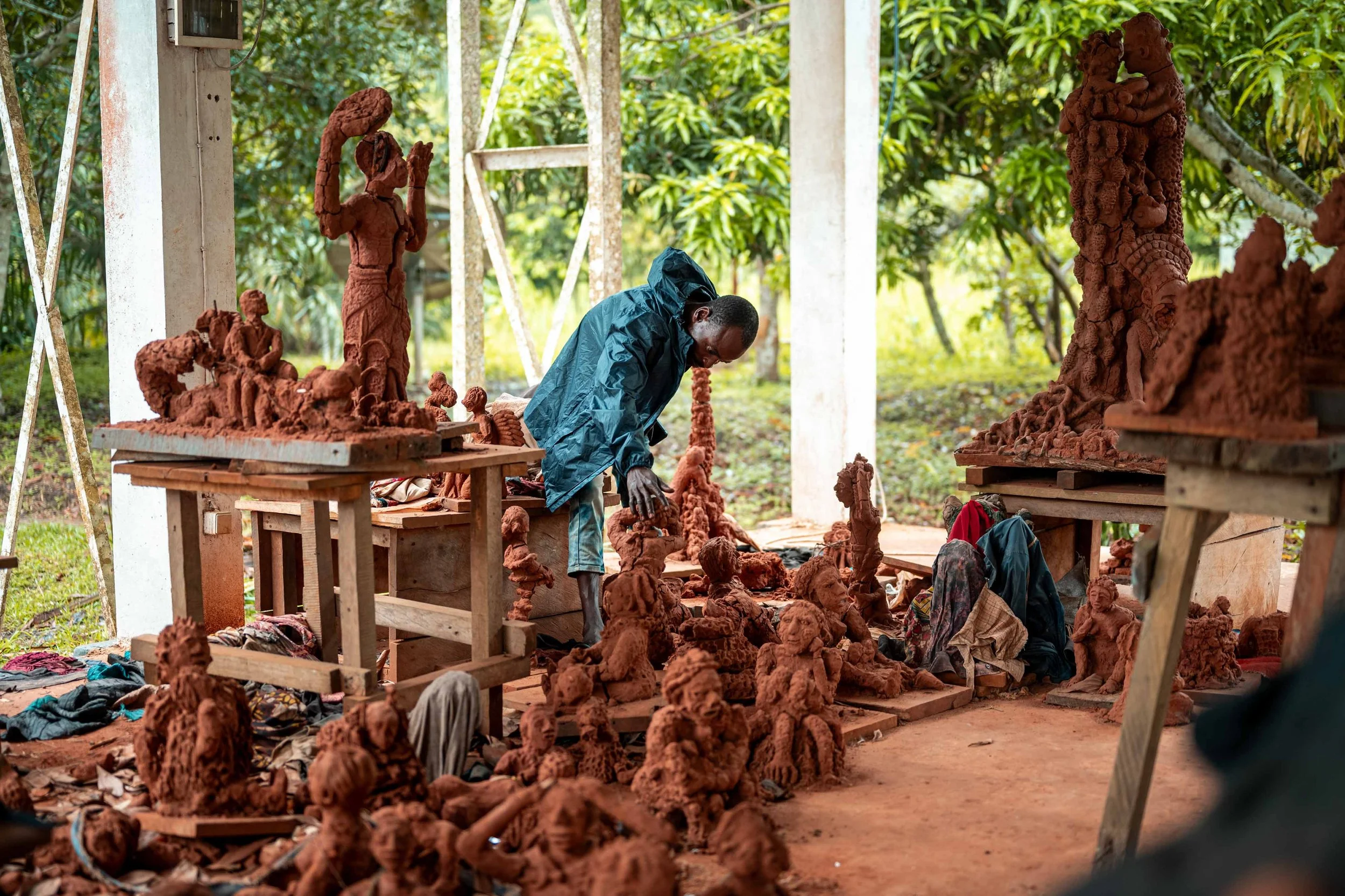 Security guard Paulin Madia inspects artworks in the CATPC workshop. Lusanga, Democratic Republic of the Congo, February 2025.