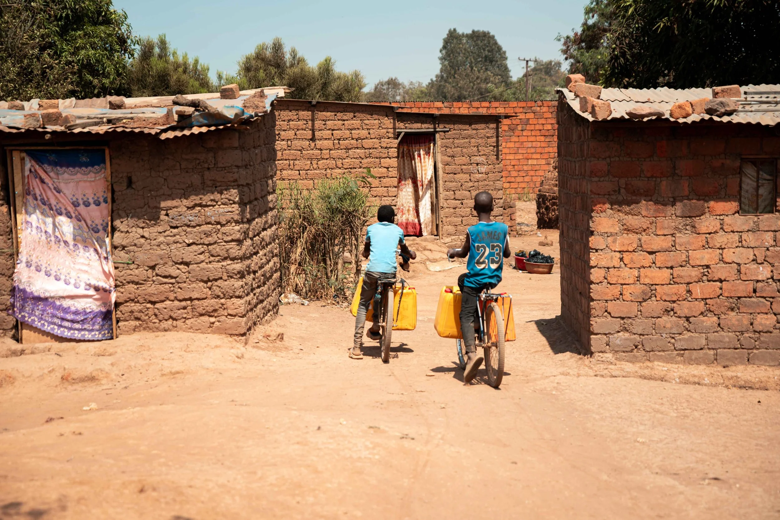 Residents of Manomapia walk long distances to fetch clean water after the local wells became contaminated. Fungurume, Lualaba Province, Democratic Republic of the Congo.