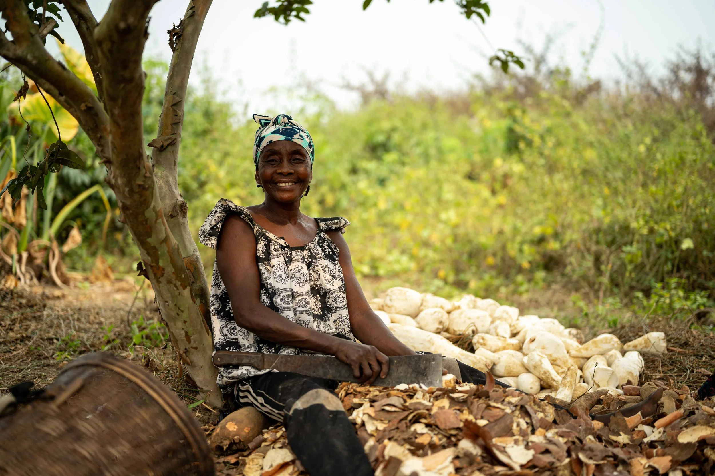 Christine Badiwé, 49, an artisan trained by the Mbou Mon Tour NGO in sustainable farming techniques, peels cassava, Mai-Ndombe, Democratic Republic of Congo, August 2025.