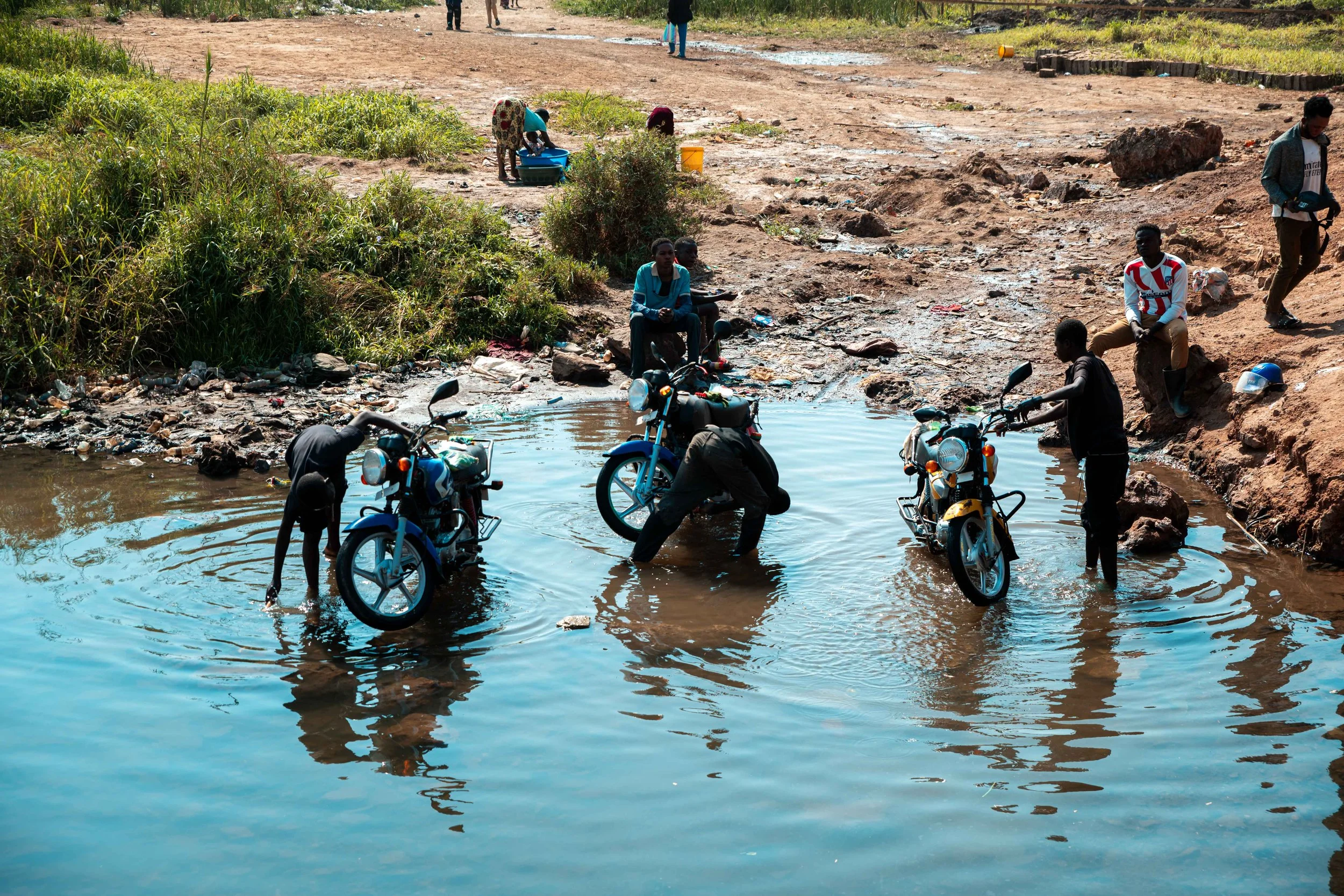 Residents use river water for daily activities despite contamination. Fungurume, Lualaba Province, Democratic Republic of the Congo.