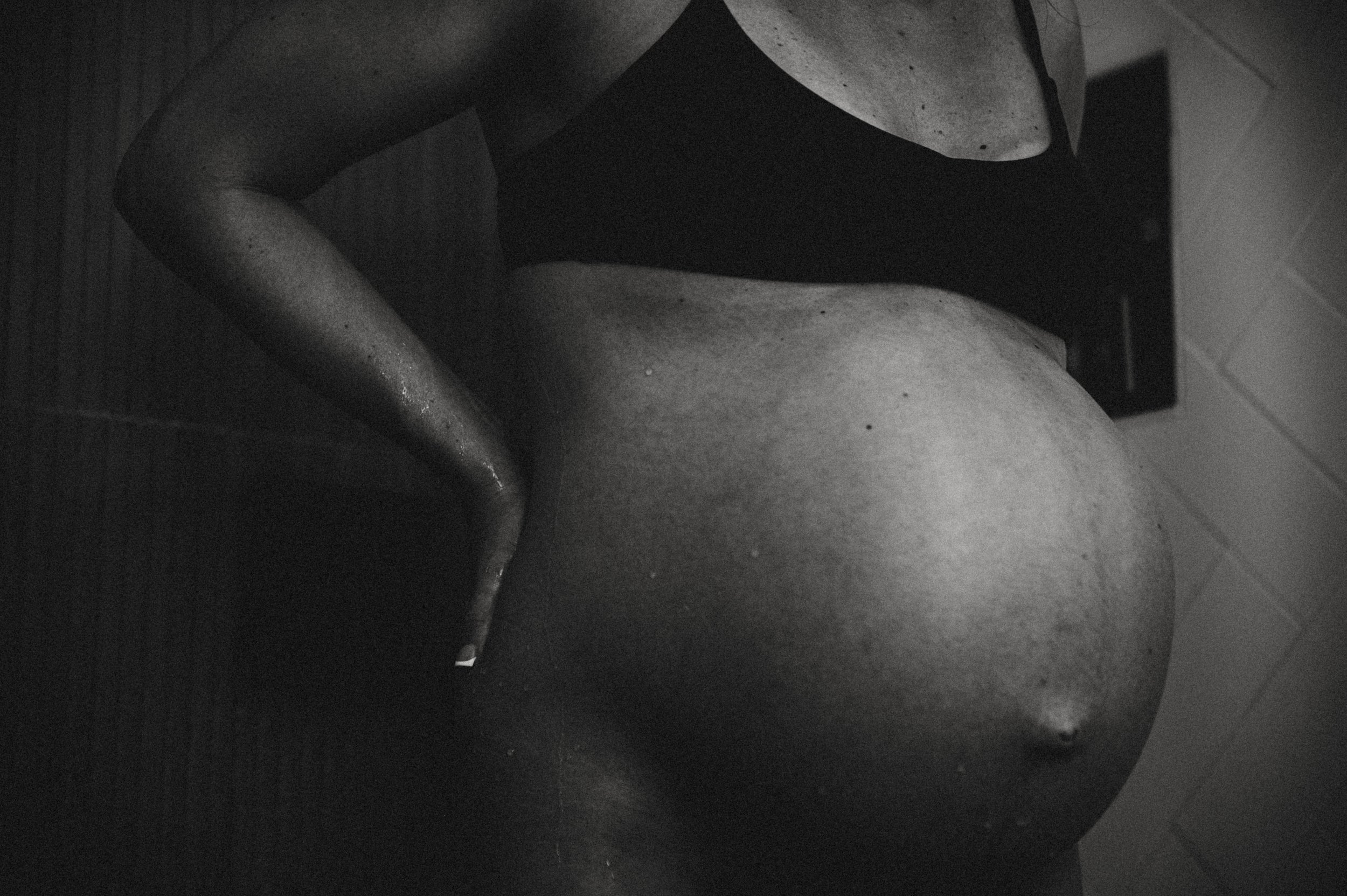 Mother laboring in shower during homebirth