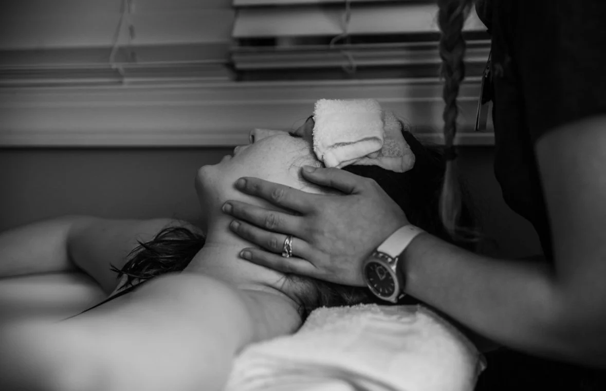 Mother laboring in tub with support at Nashville Vanderbilt Birth Center