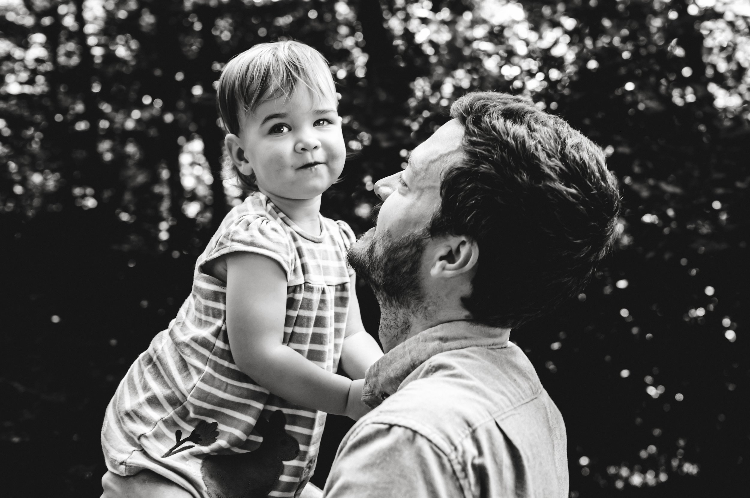 Nashville Summer creek session. Dad playing with daughter during family photo session.