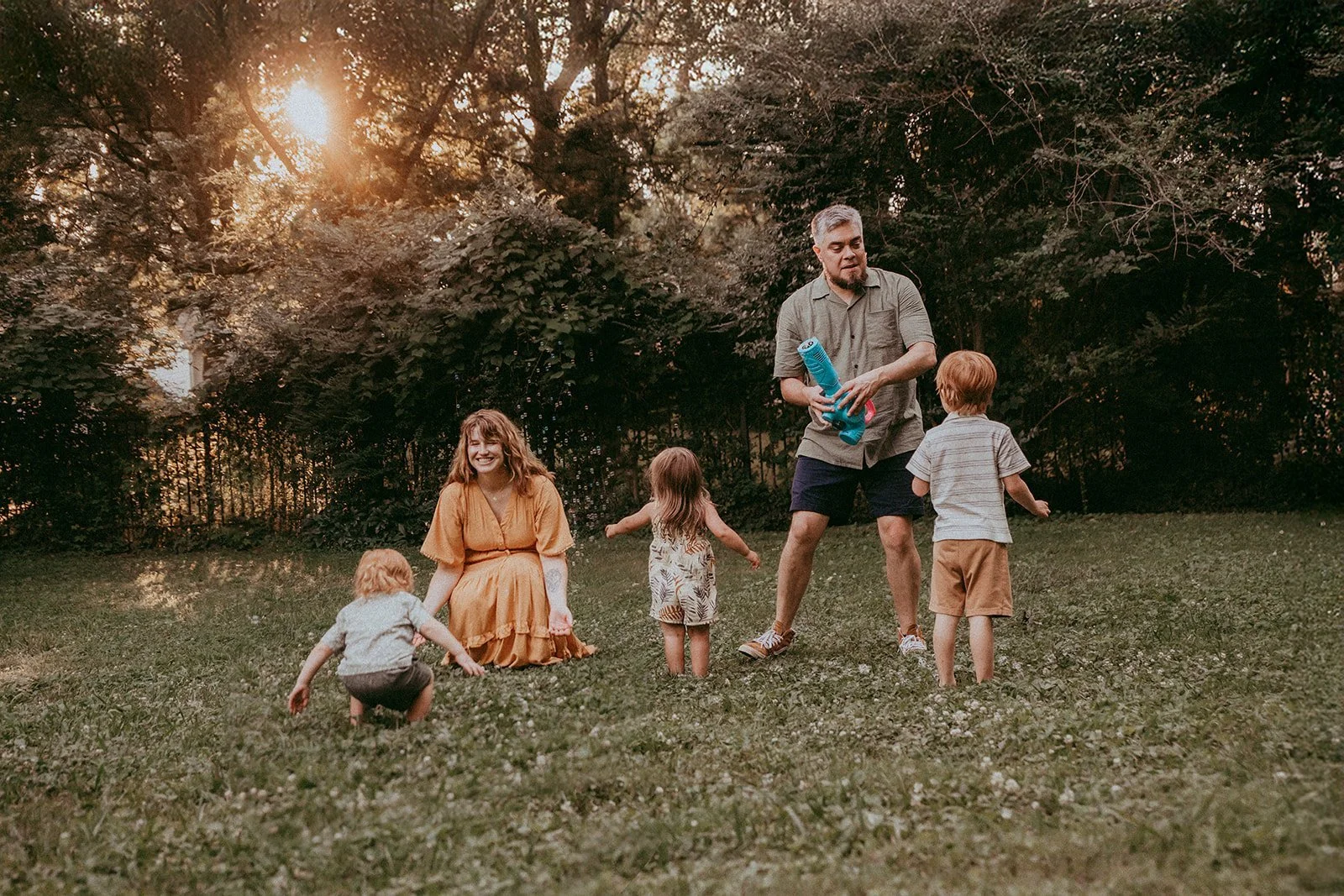 Family photo and film session shot at home. Children running and playing in their backyard.