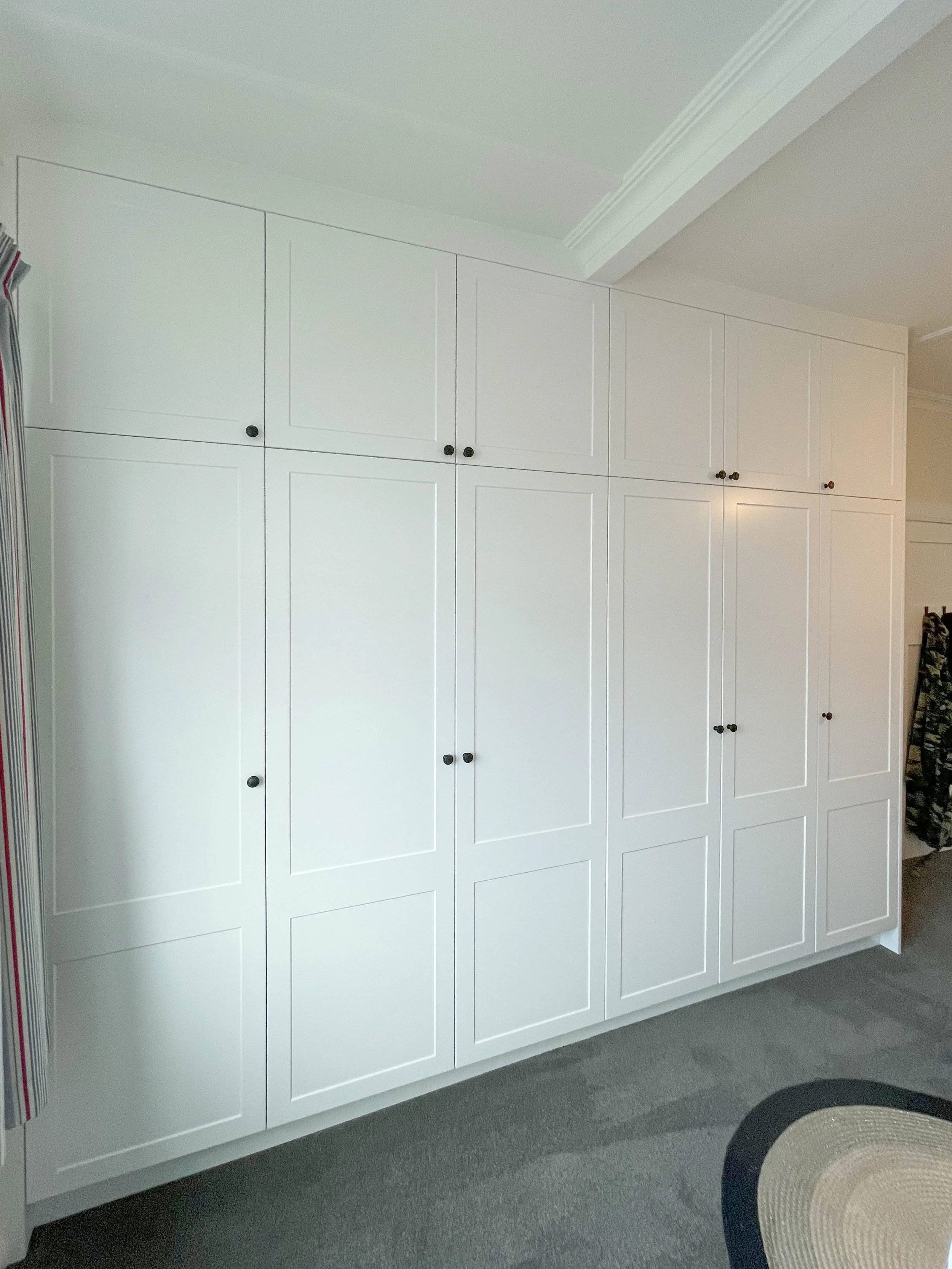 White panel wardrobe with black handles