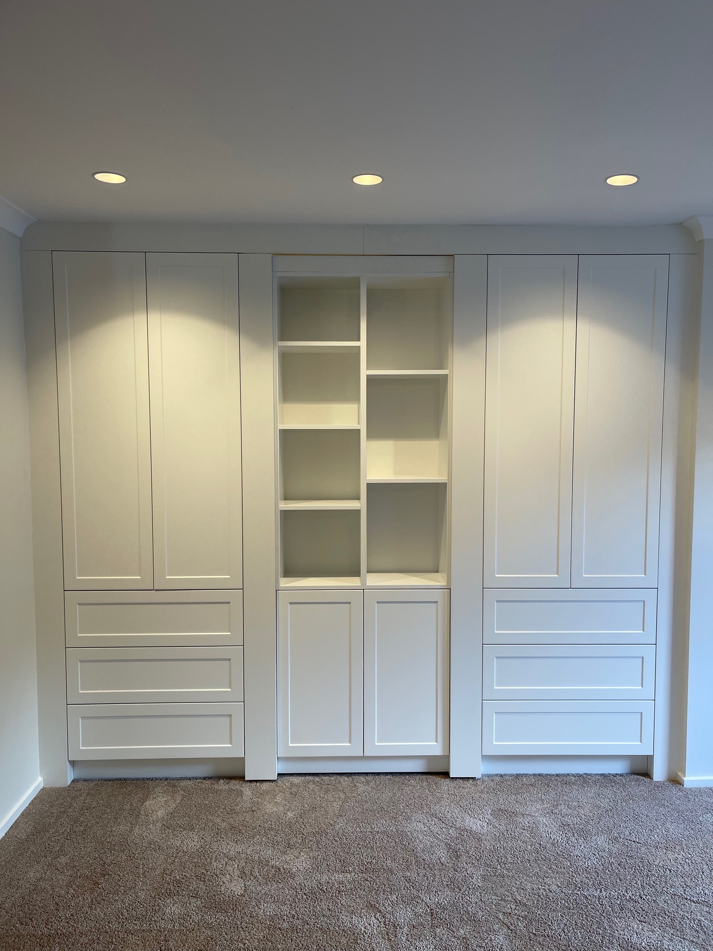 White panel door wardrobe with cubbie spaces, and drawers