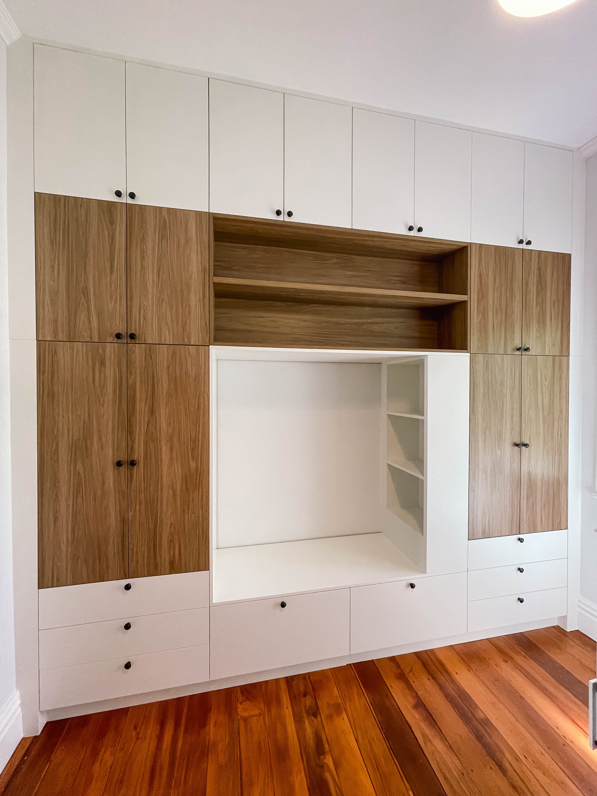 White and timber look melteca flat door wardrobe with black handles