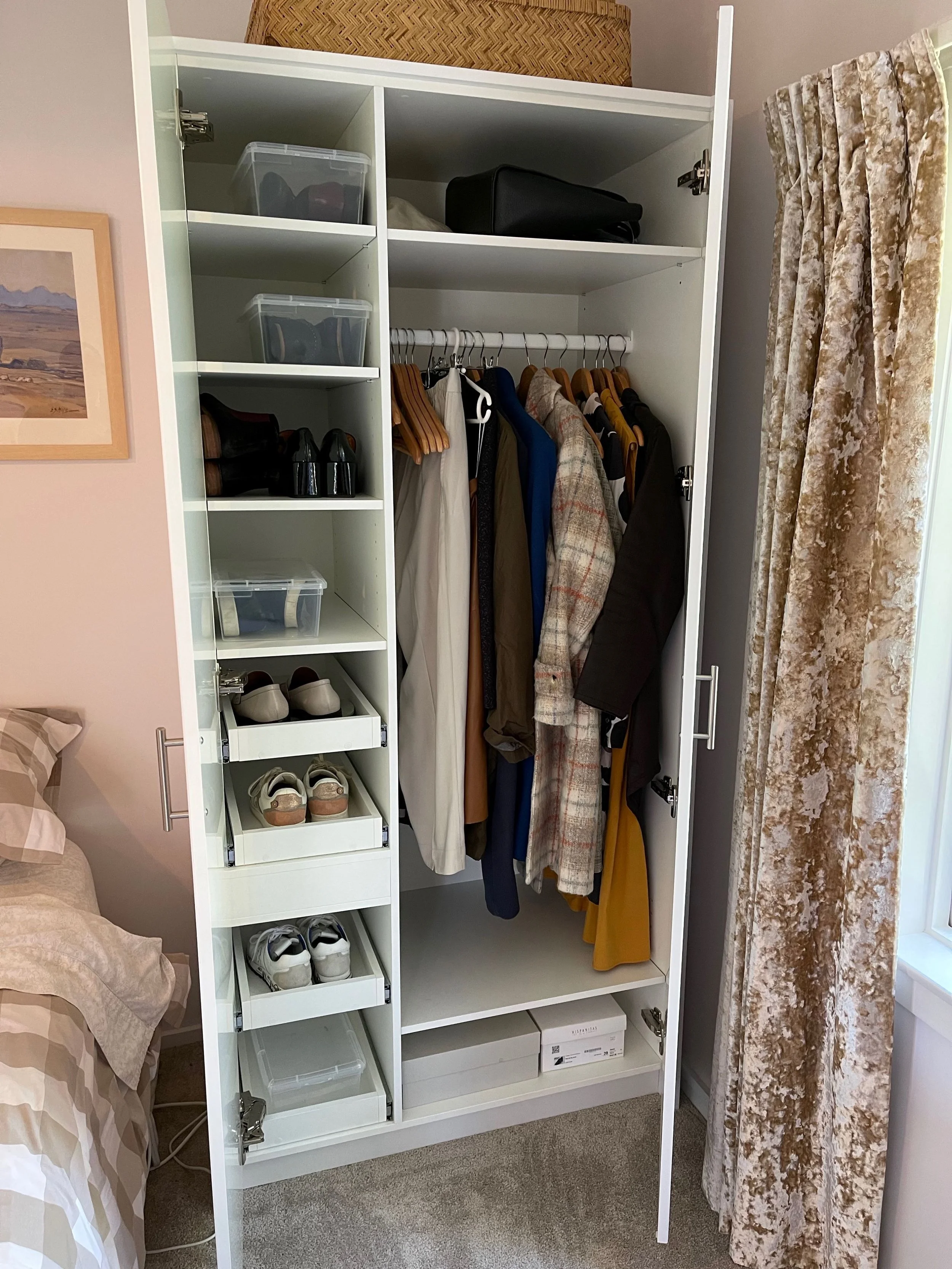 Free standing wardrobe open view showing clothes hanging space, shelves with shoes and other storage items