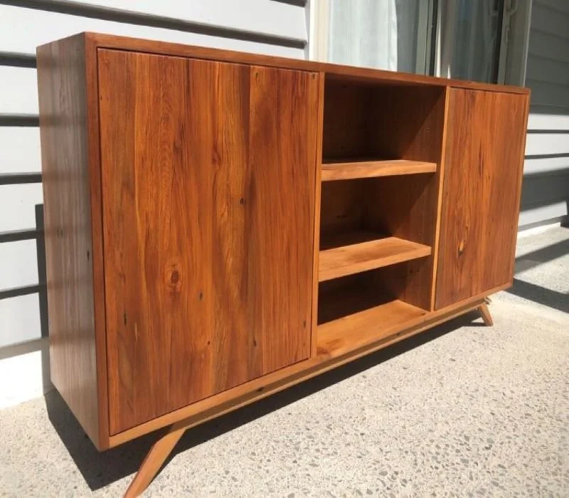 Wooden credenza with 2 cabinets, one either end of the unit and 2 shelves in the middle