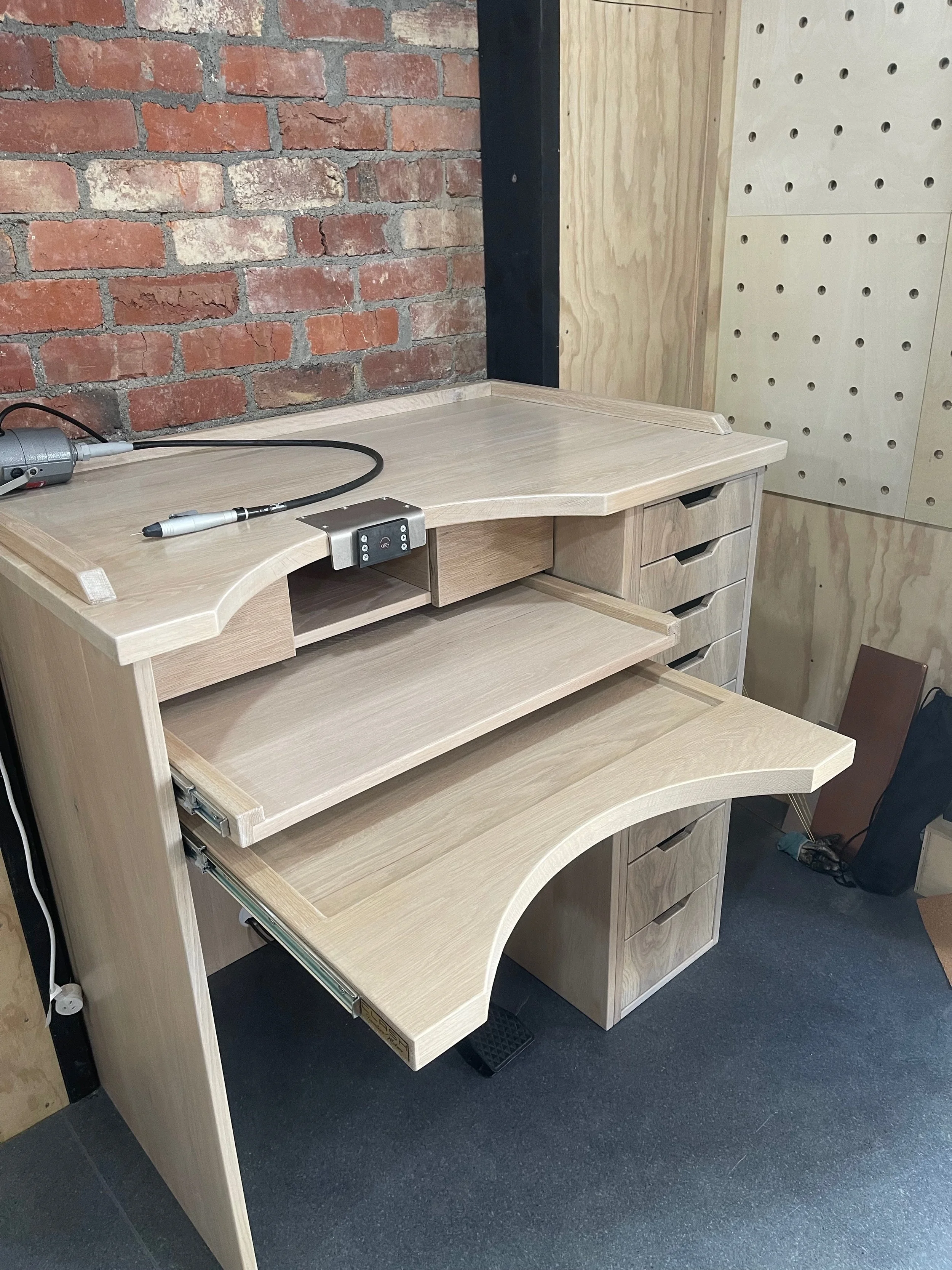 American oak jeweller's with cut outs at the tops of the drawers to act as handles. The two additional pull out work bench  spaces are pulled out to show what they look like