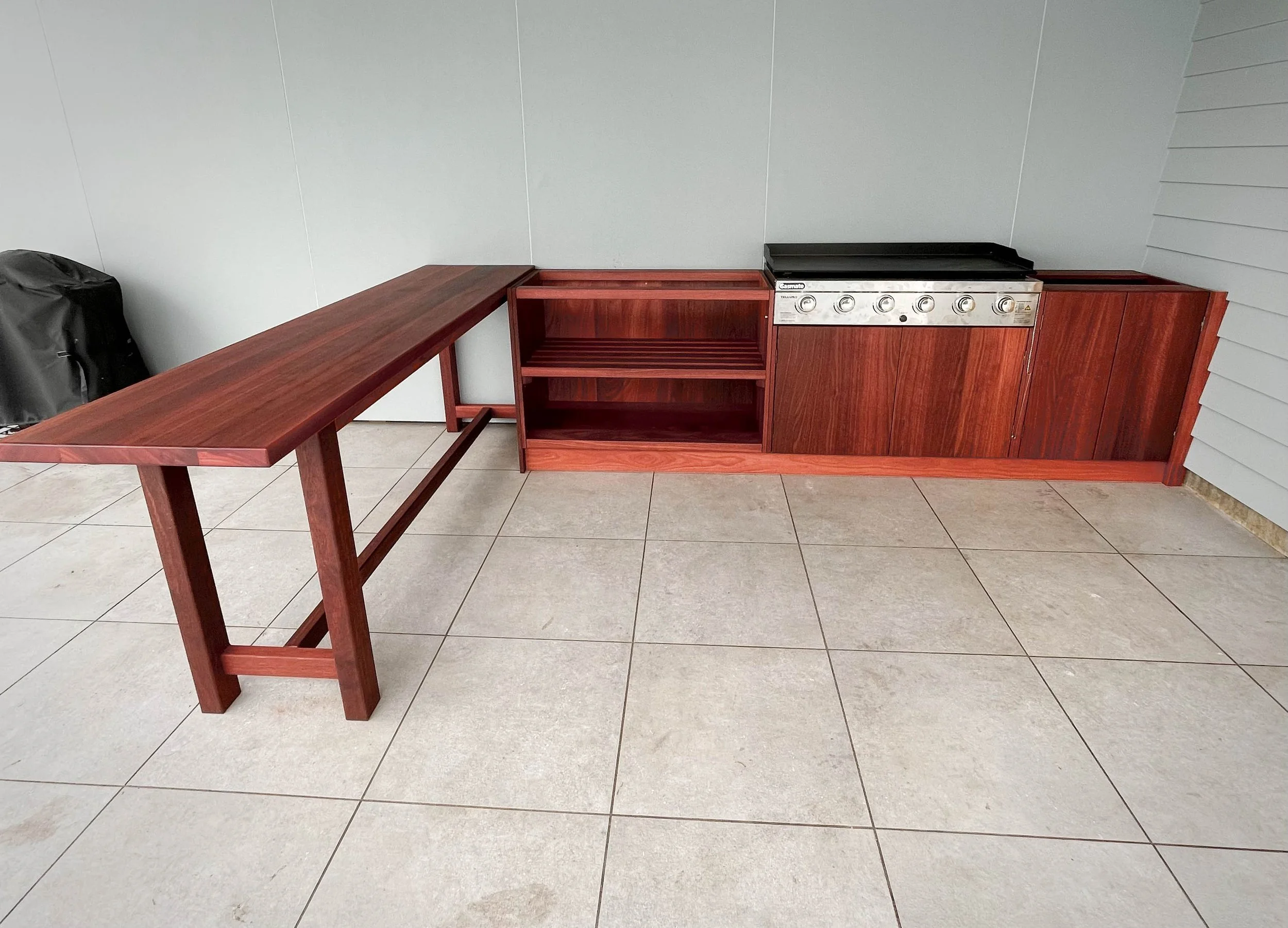 Solid Jarrah Outdoor Kitchen with bar leaner. Stainless steel built in BBQ in middle of unit