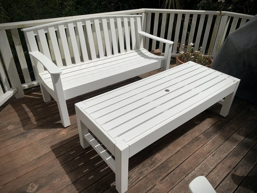 White wooden bench seat and table on deck  