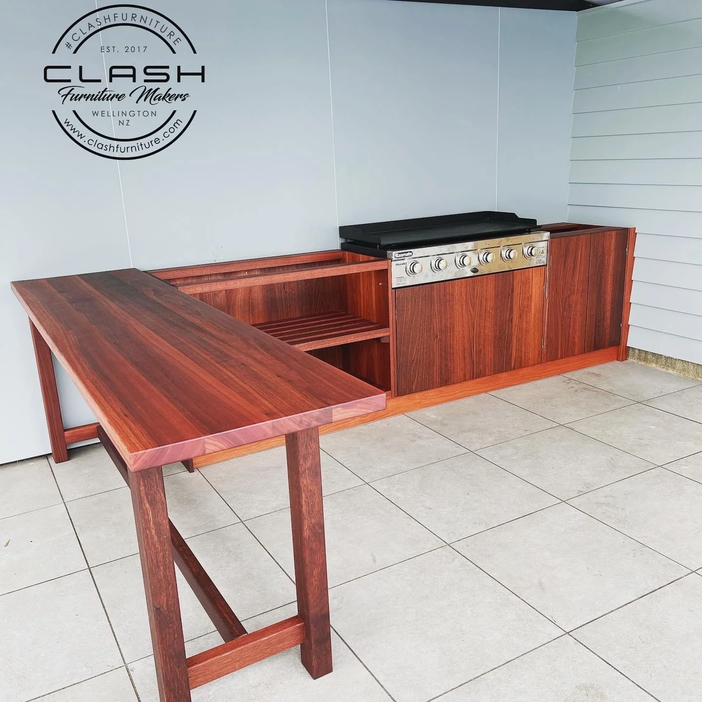 Solid Jarrah Outdoor Kitchen with bar leaner. Stainless steel built in BBQ in middle of unit