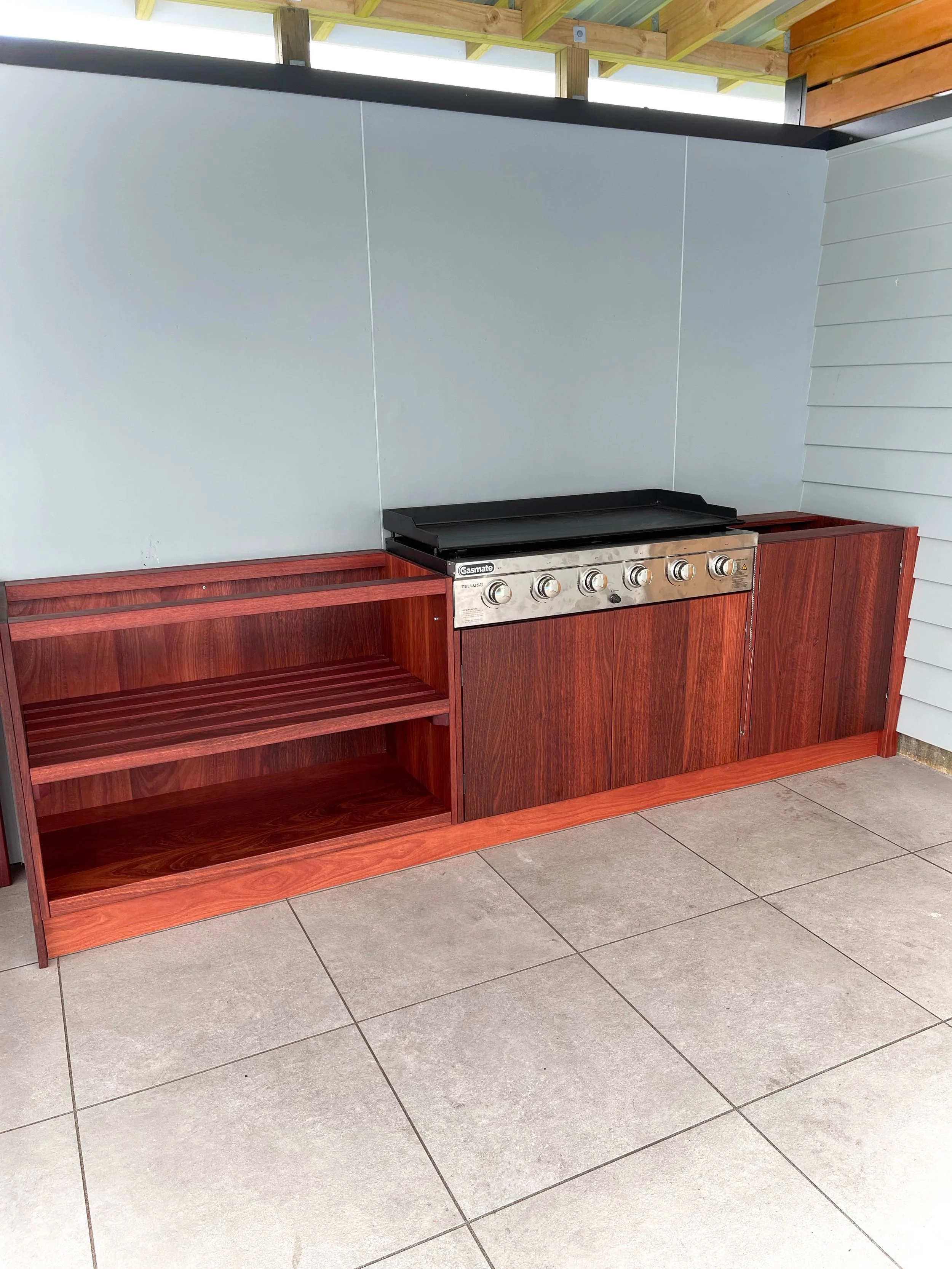 Solid Jarrah Outdoor Kitchen with bar leaner. Stainless steel built in BBQ in middle of unit