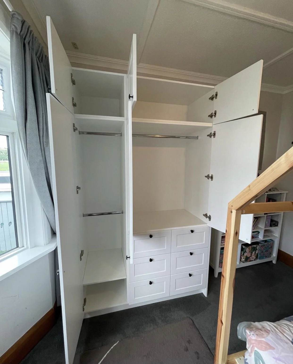 Free standing panel door wardrobe open view showing hanging spaces for clothes