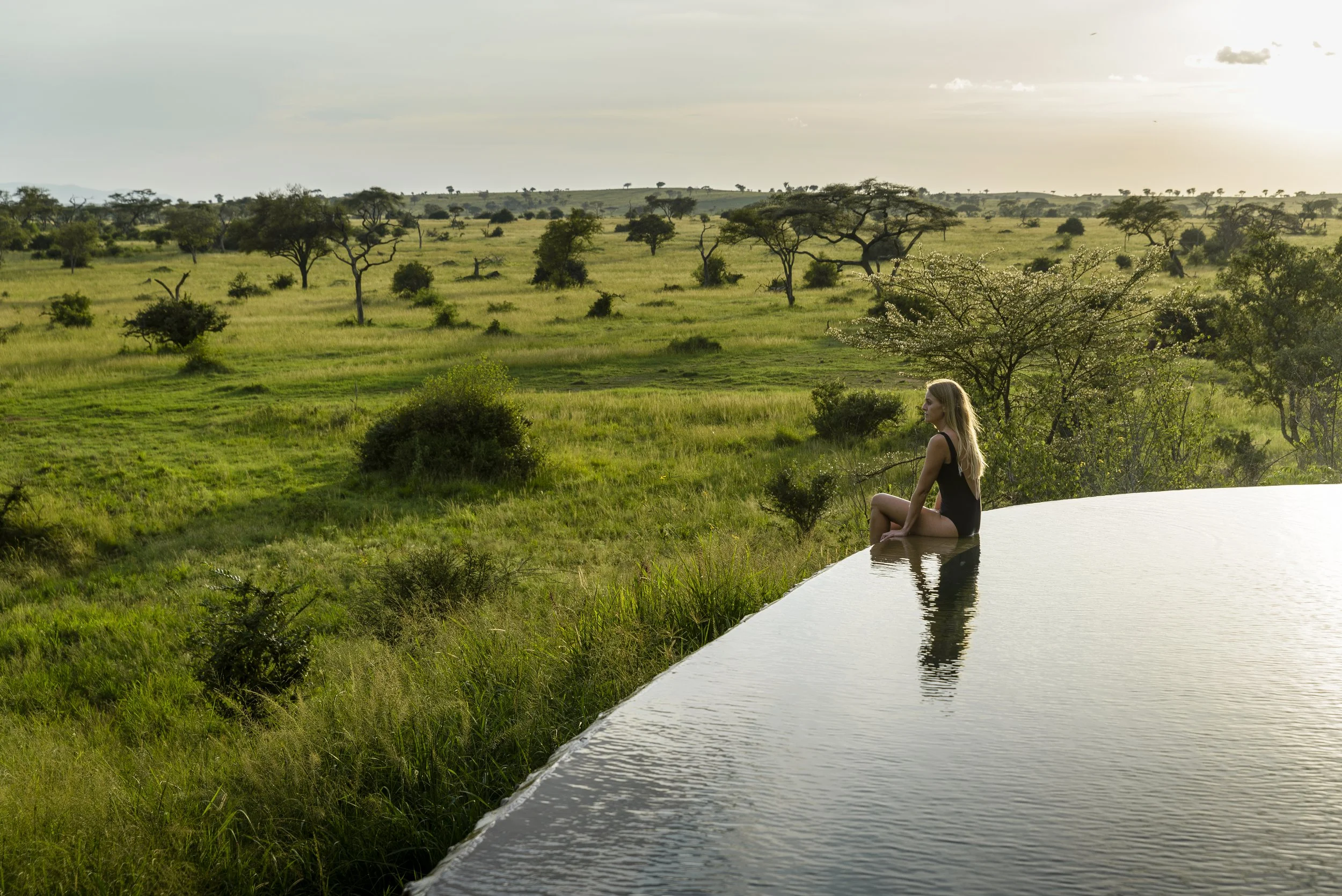 Singita Grumeti_Wellness_Guest meditating at edge of pool.jpg