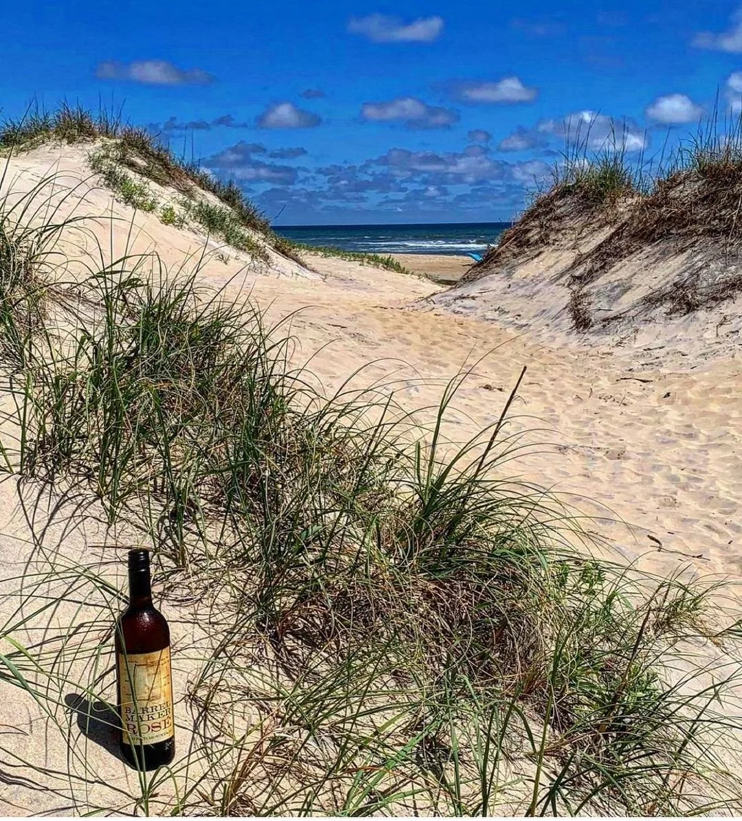 Bottle of Cooper Wine in a sandy mountain scene