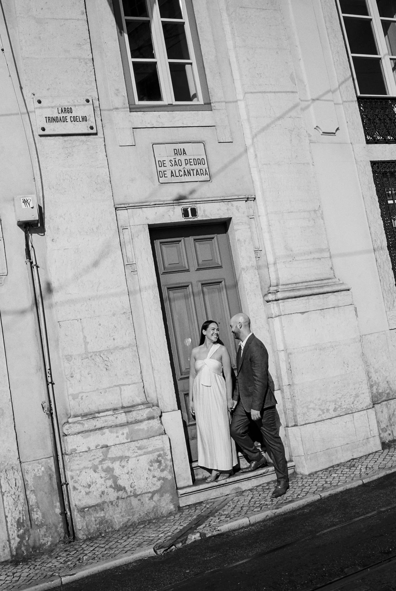 Bride and groom side by side in front of a typical Portuguese building during their elopement in Lisbon