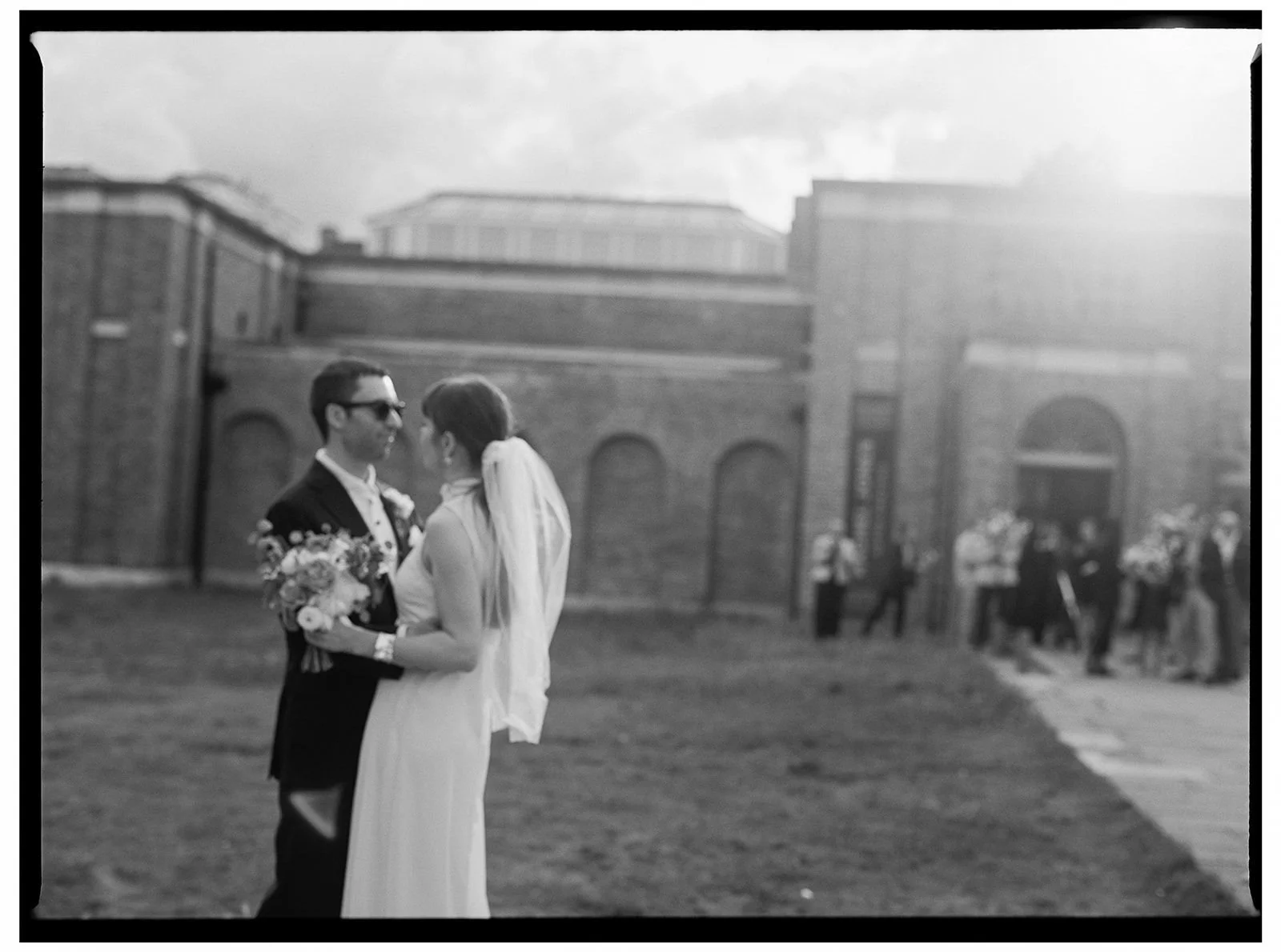 Bride and groom captured on BW medium format film in front of Dulwich Picture Gallery.