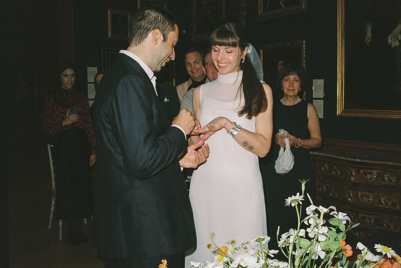 Bride and groom exchange rings at Dulwich Picture gallery