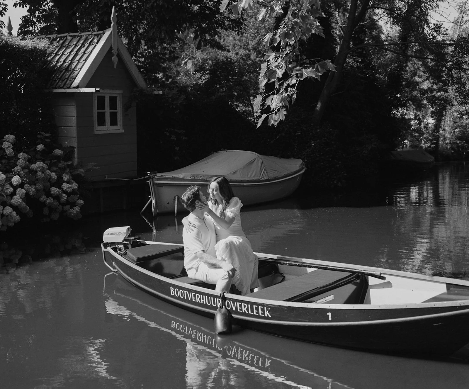 bride and groom on a boat in a picturesque setting photographed on BW film