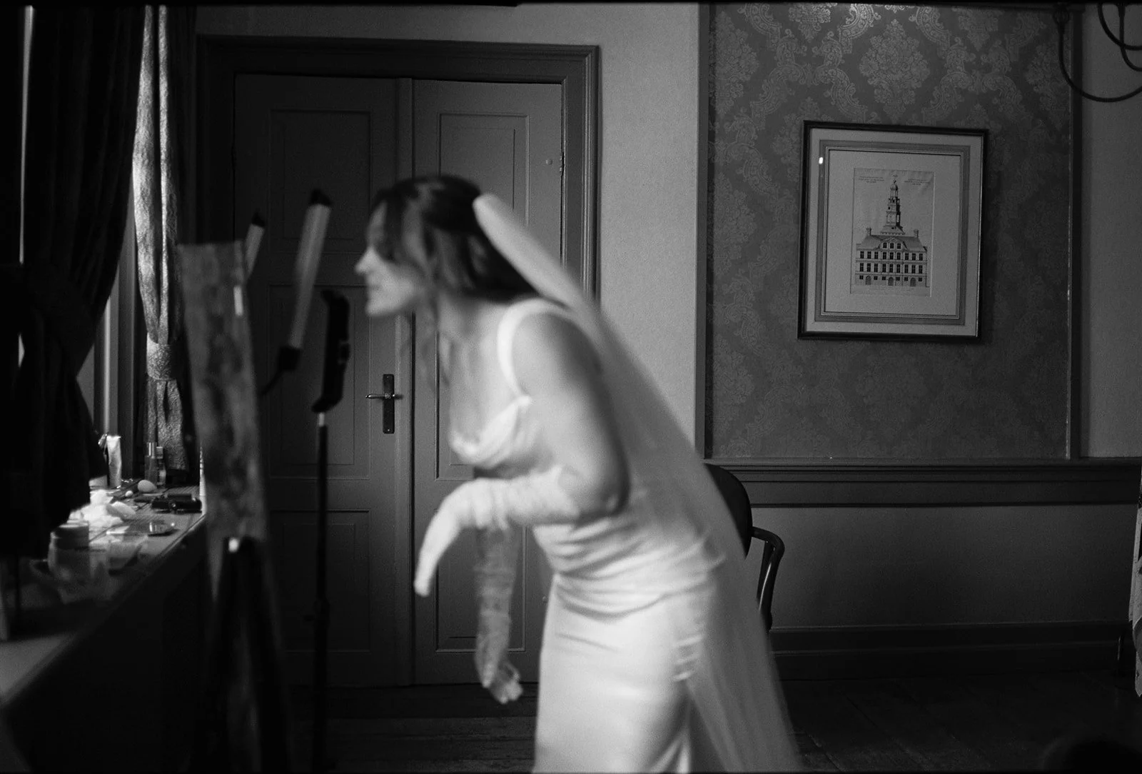 Bride looks herself in the mirror at Chateau Neercanne wedding