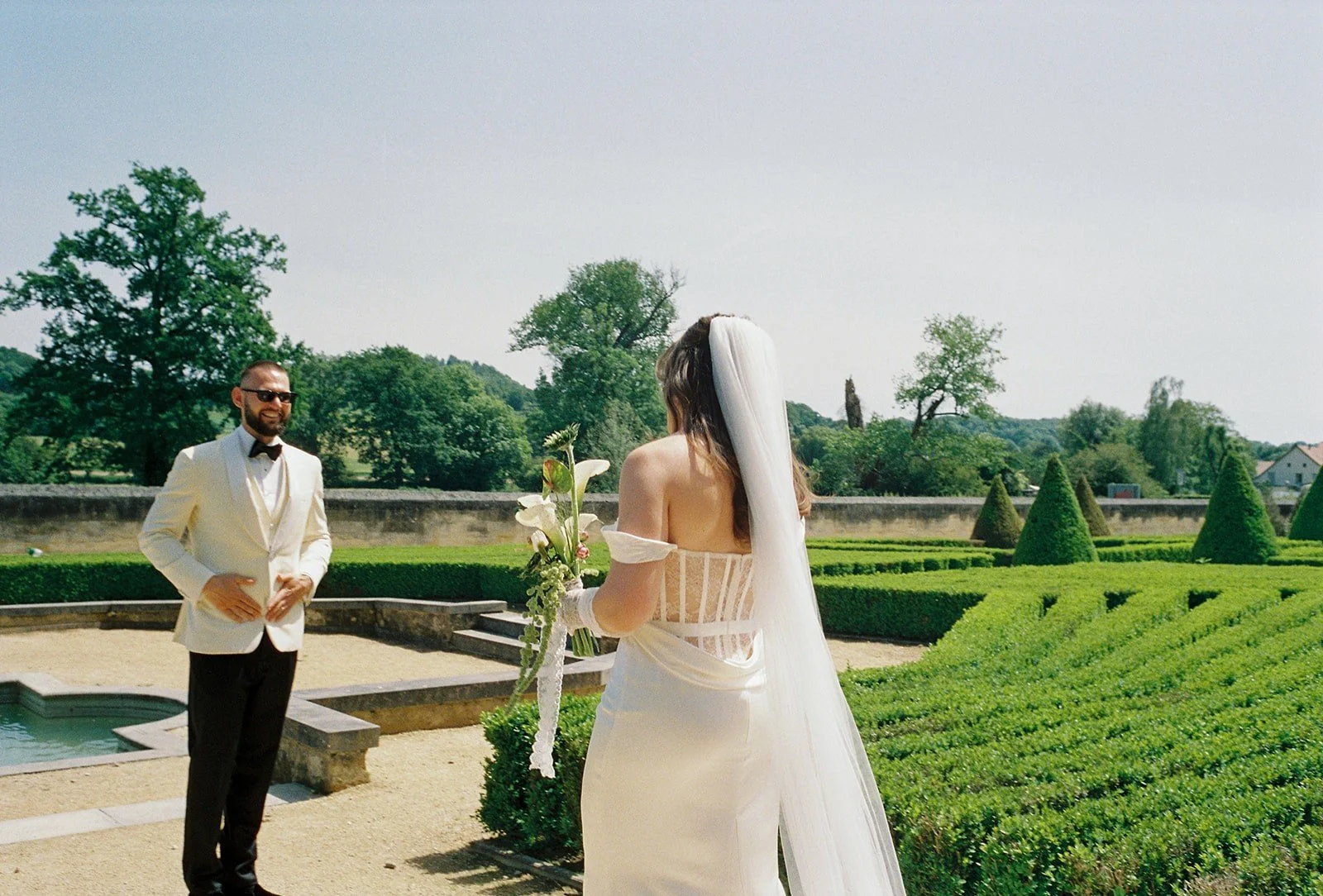 Groom smiles at bride at first look at Chateau Neercanne wedding