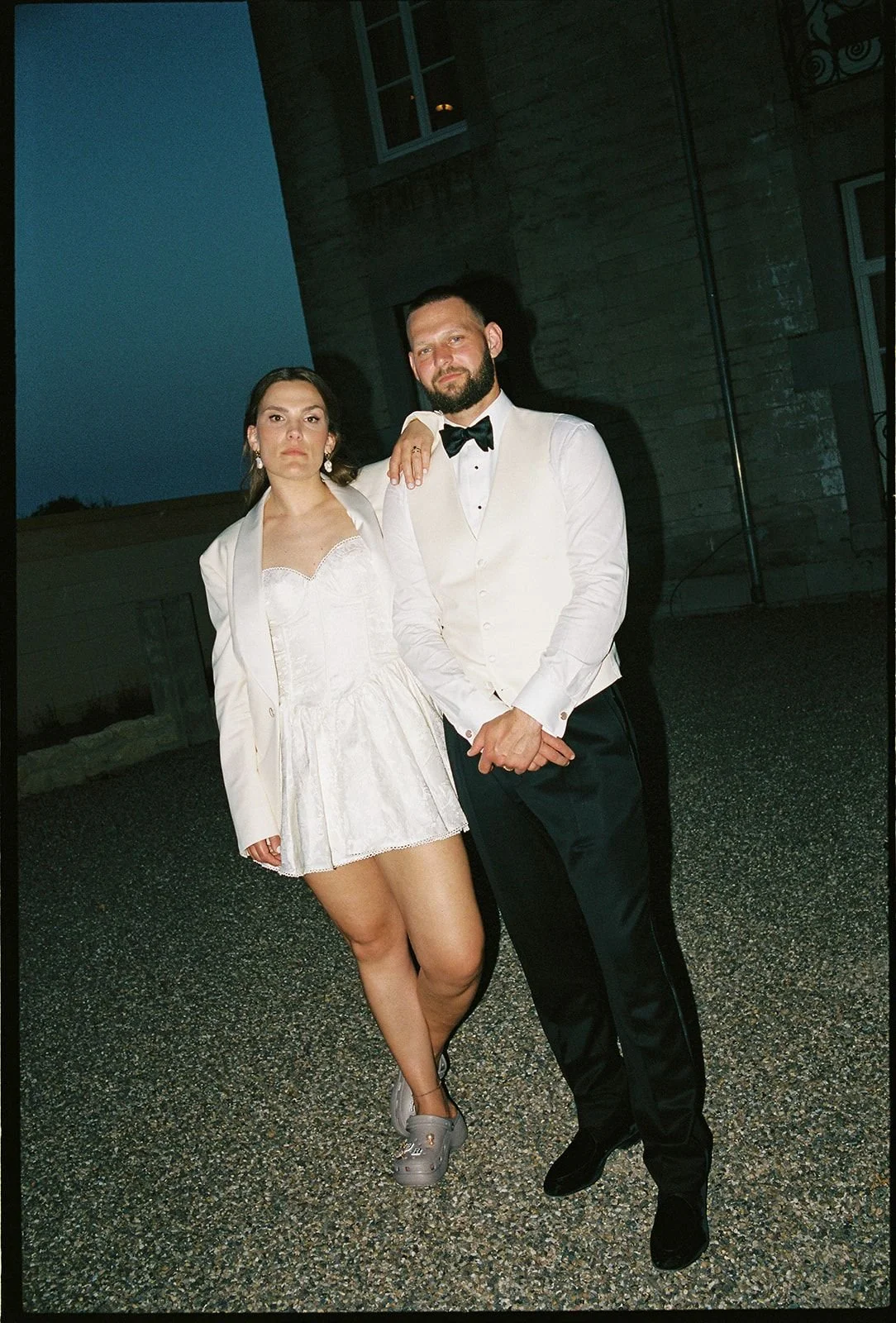 Couple posing for wedding portrait in front of Chateau Neercanne