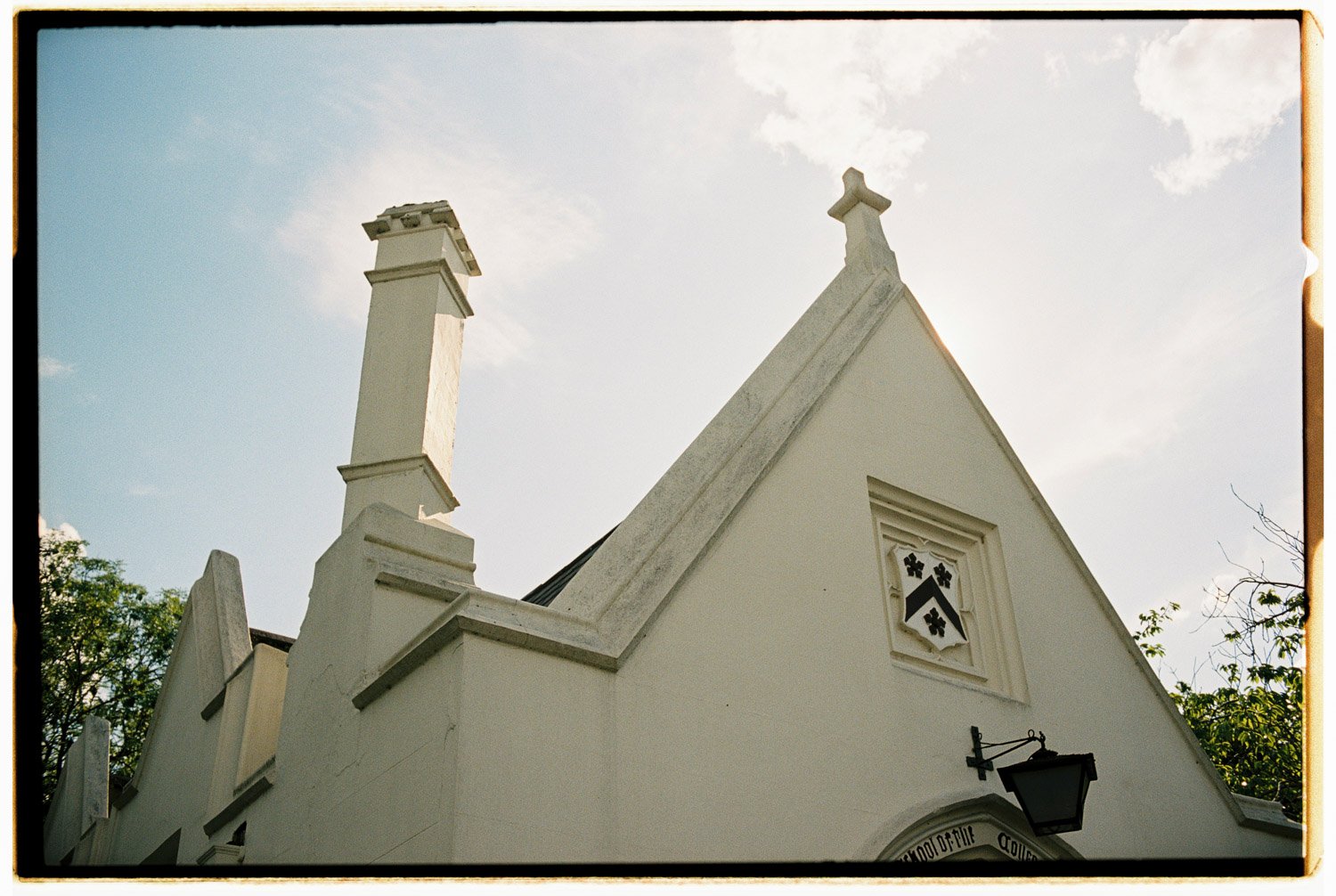 a small white church photographed against a blue sky on film by film wedding photographer in Provence