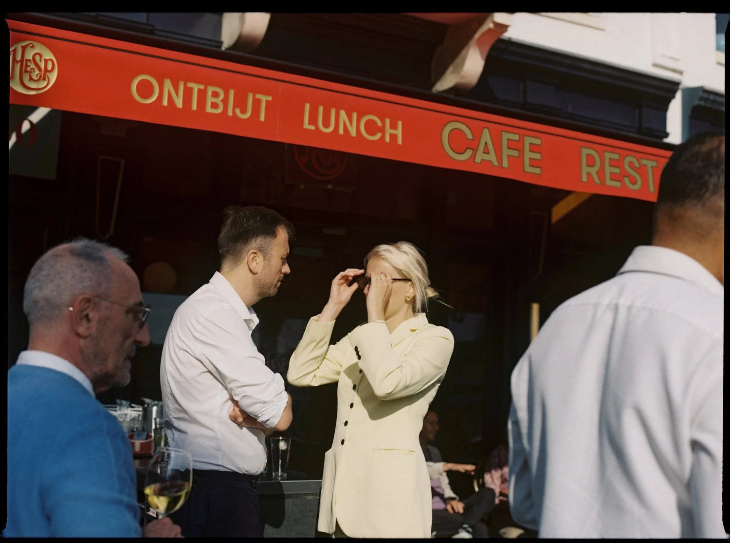 colorful scene of wedding guests talking during sunset, by film wedding photographer in Provence
