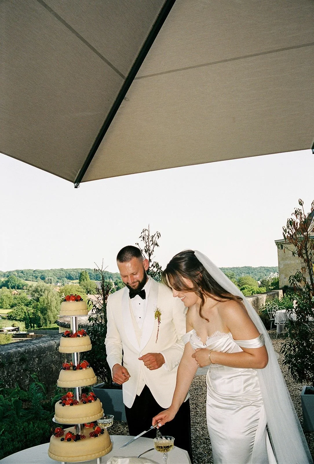Bride and groom cutting their cake at Outdoor terrace at Chateau Neercanne