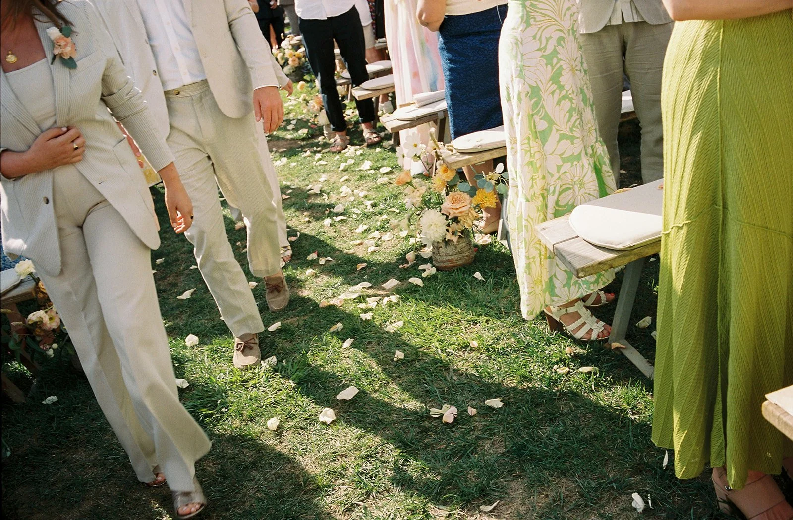 Petals on wedding at casa sacoto while guests walk in pastel colors.