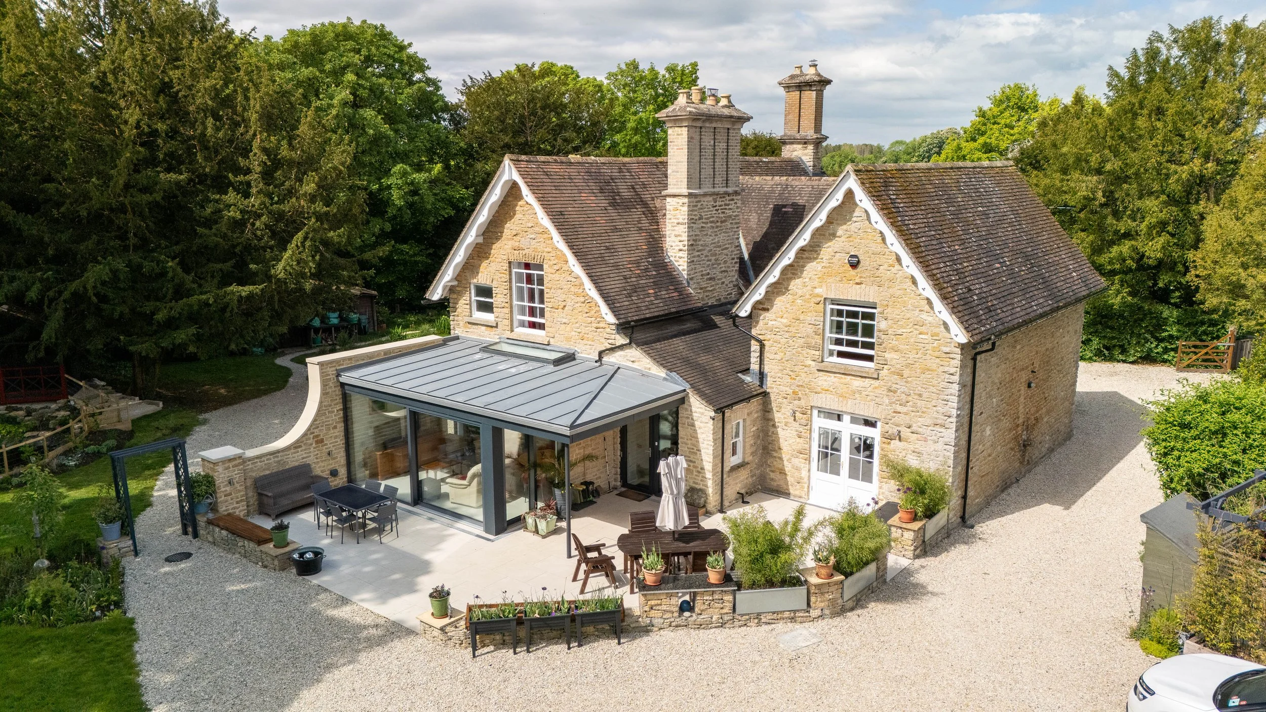 Elevated view of the new zinc-roofed garden extension blending with the original stone property.