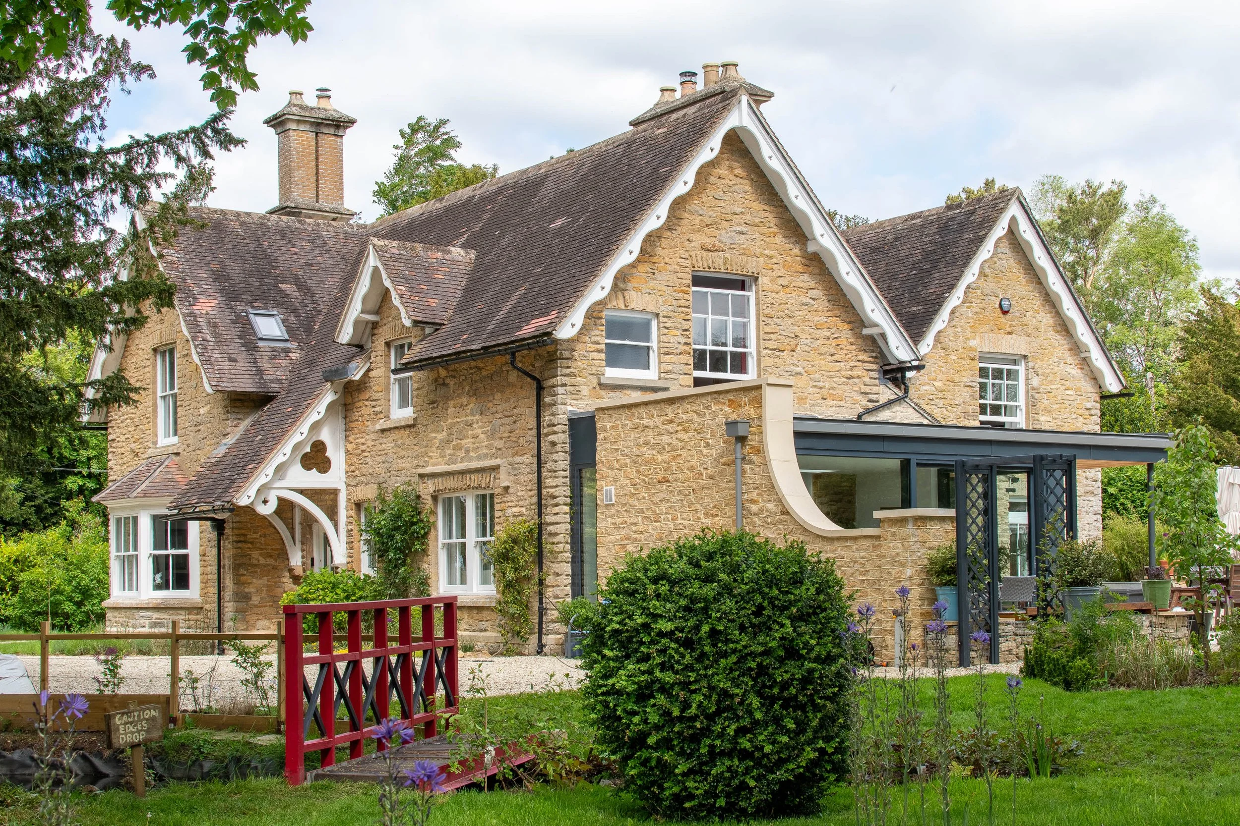Sleek, grey aluminum structural framing contrasting against traditional stone masonry.