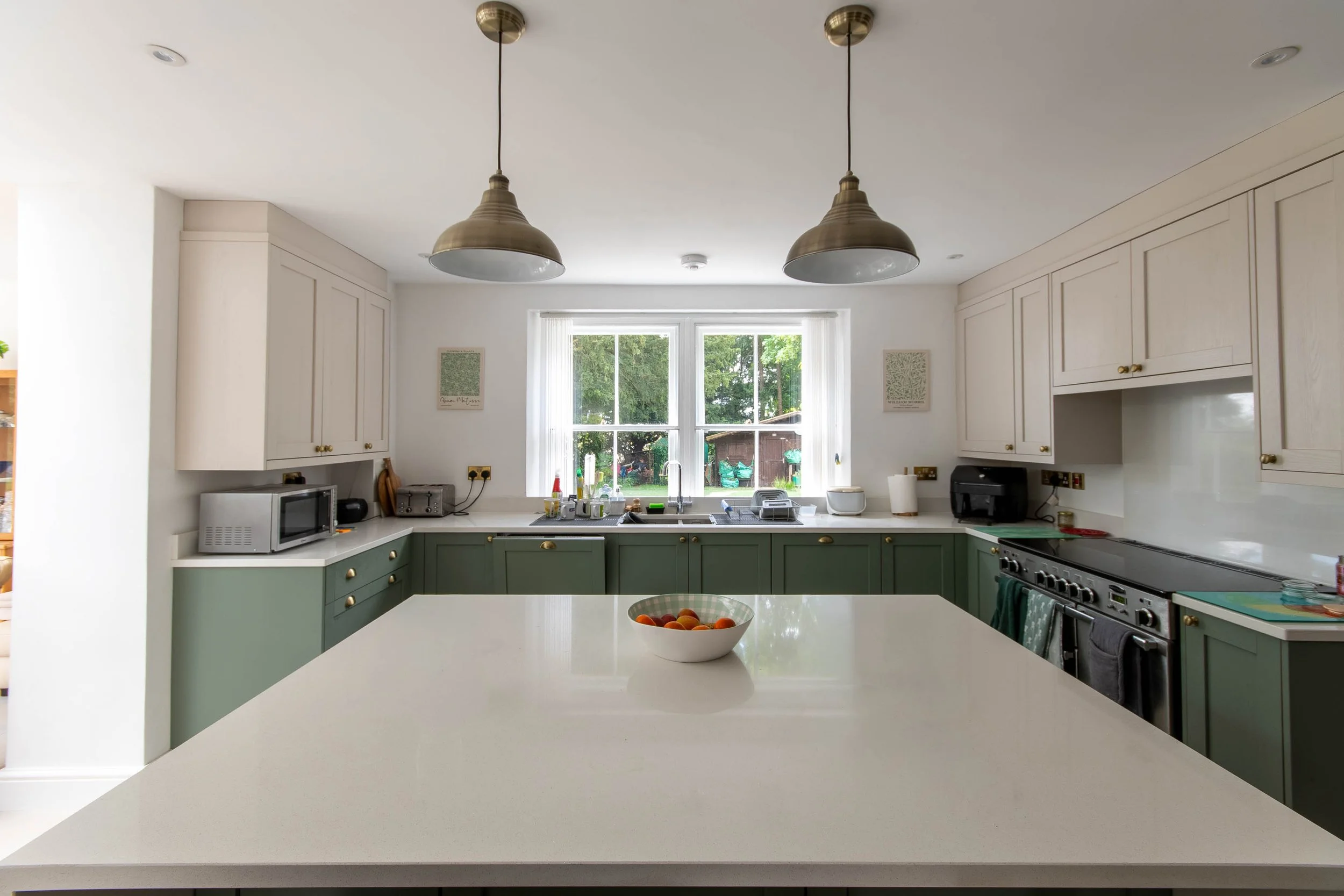 High-specification open-plan kitchen design featuring a large central island and shaker-style cabinetry.