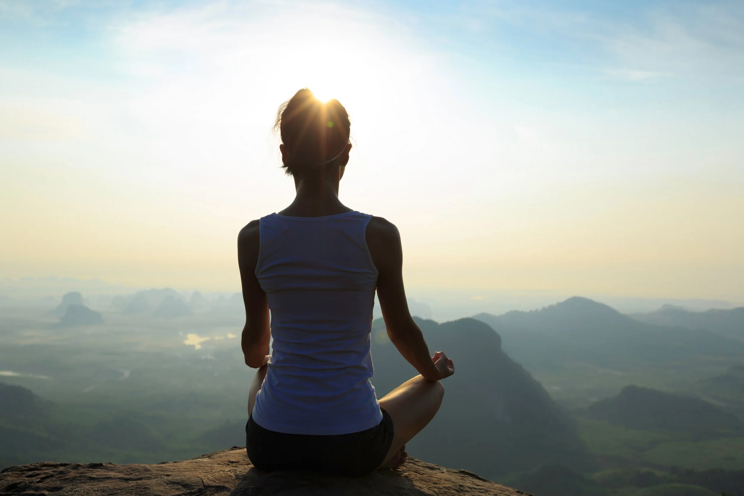 meditation-on-sunrise-mountain-top-cliff-edge-PRKPWCG.JPG