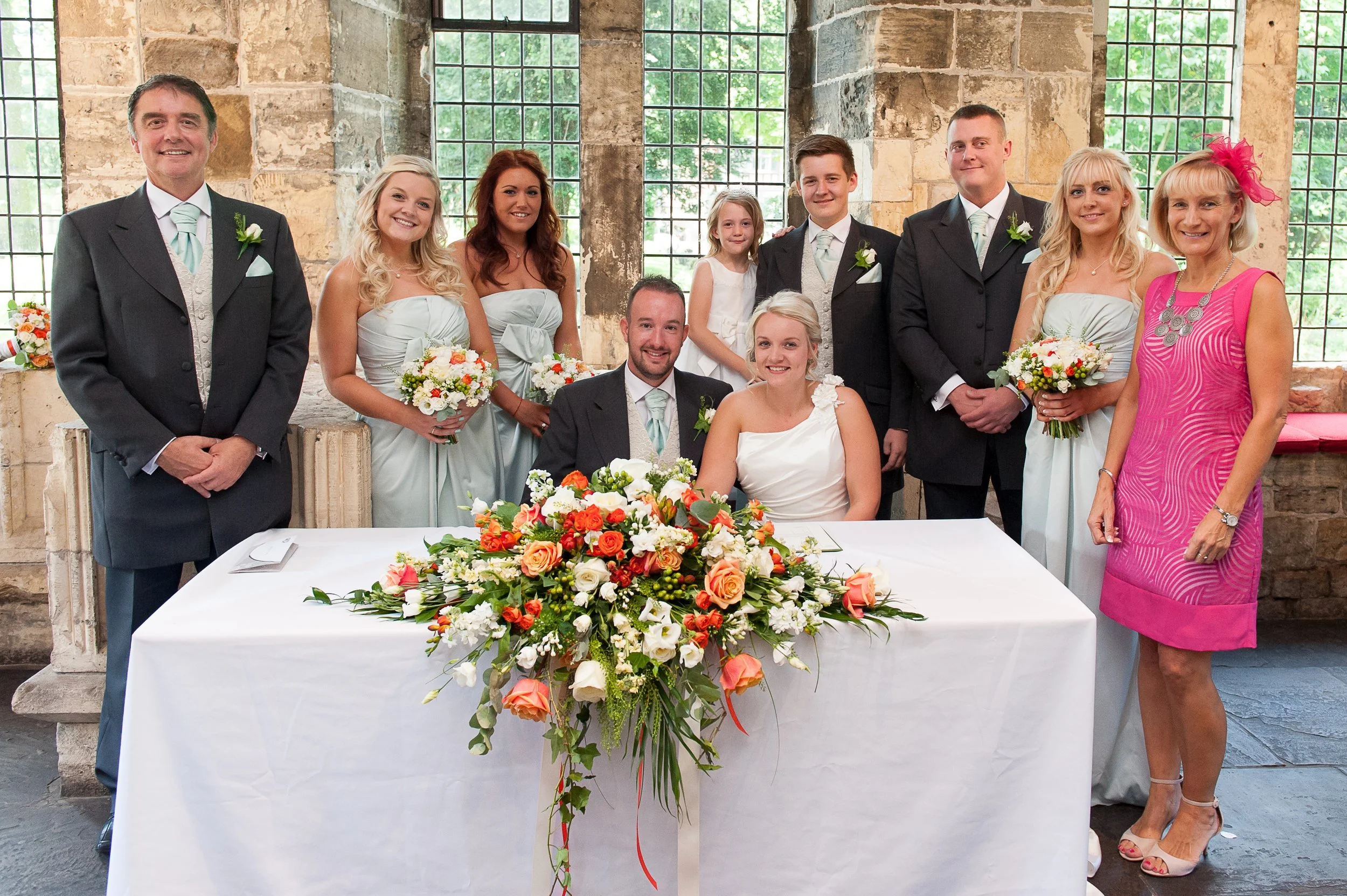 Couple sign the wedding register at The Hospitium with family and friends