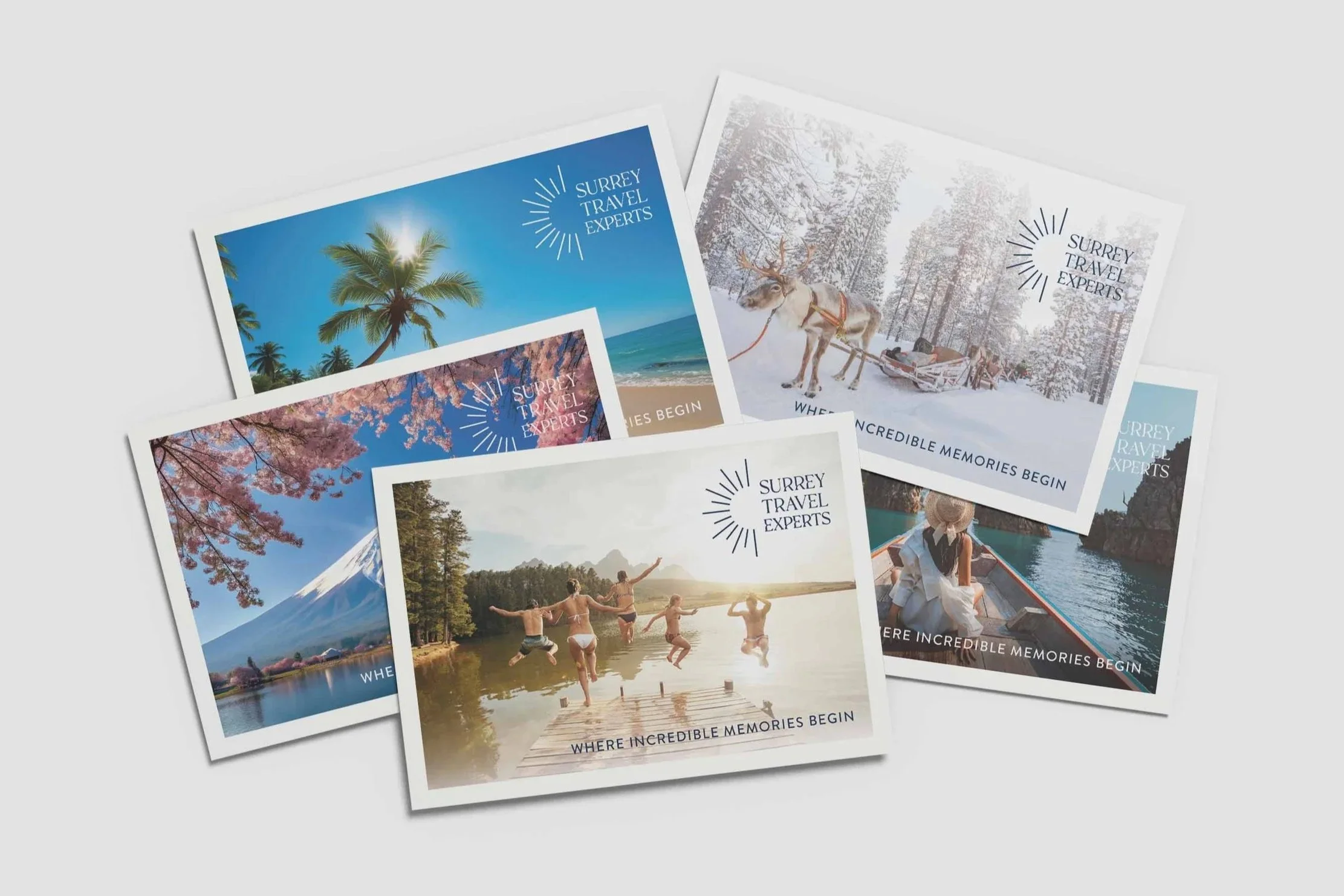 Collection of travel brochures for Surrey Travel Experts featuring images of tropical beach with palm trees, snowy forest with reindeer, cherry blossoms, people jumping into a lake, and a woman on a boat in a canyon.
