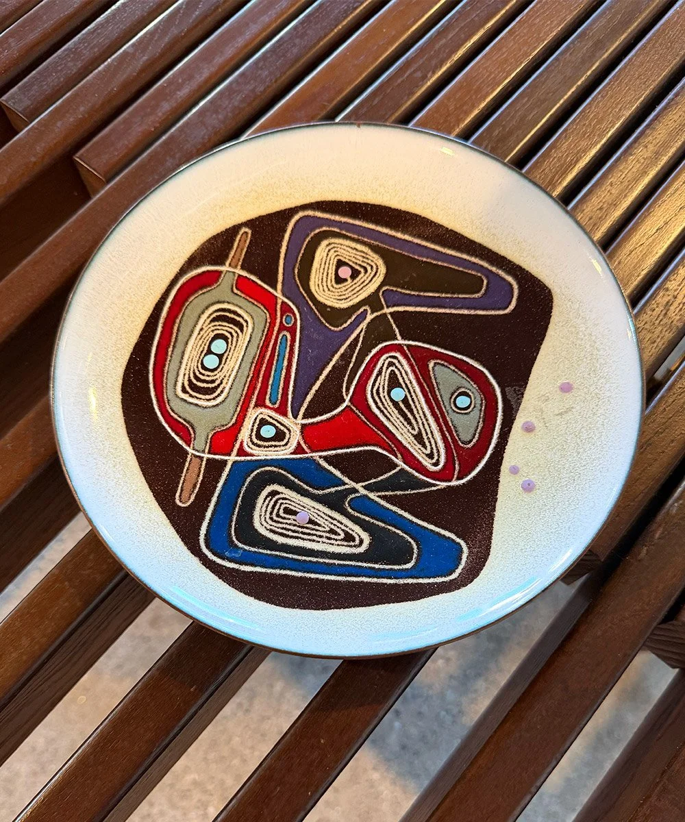 Vintage mid-century modern ceramic plate featuring a colorful abstract atomic design. A unique decorative accent for modernist and MCM interiors.