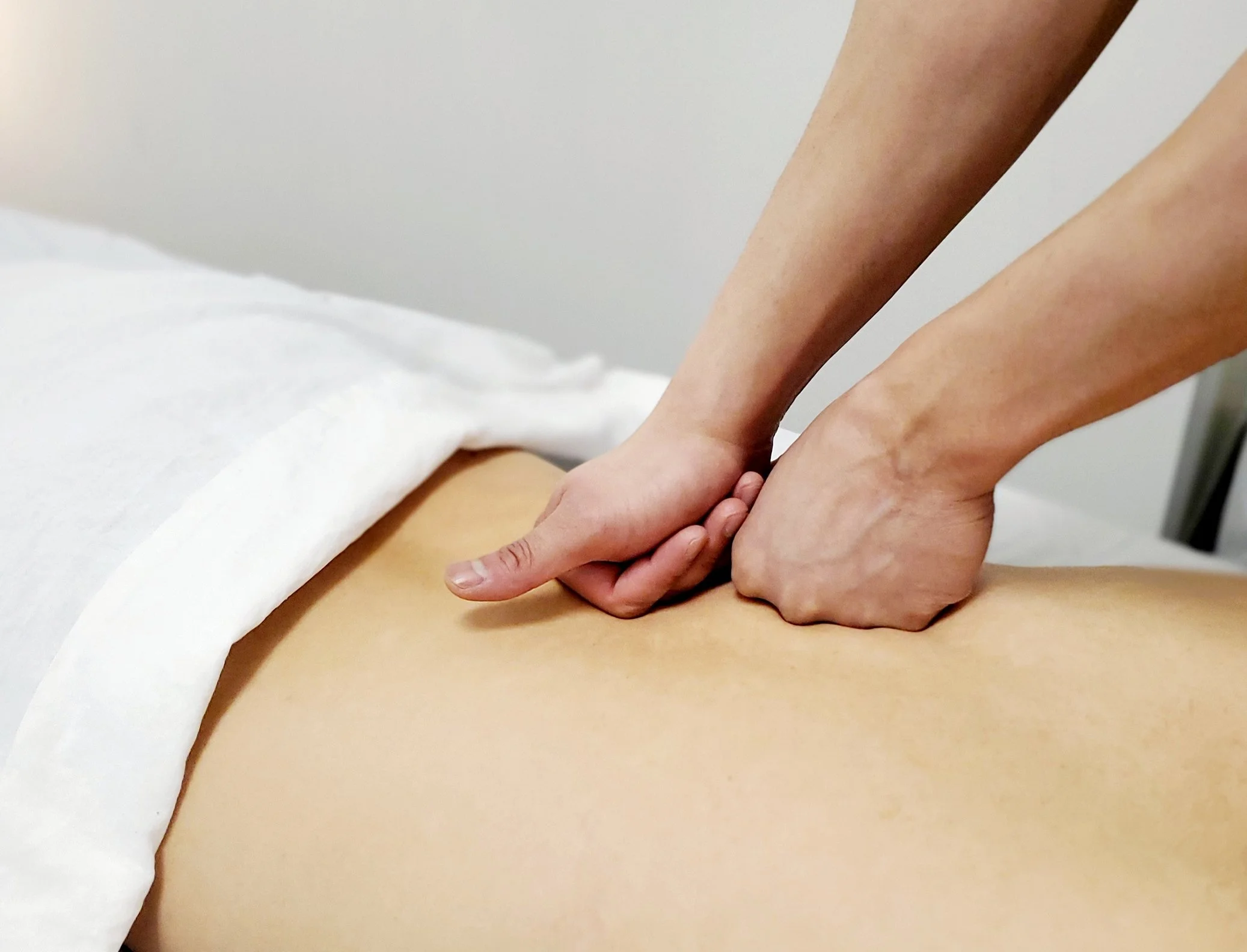 Registered Massage Therapist (RMT) performing deep tissue massage for neck and shoulder tension at Amity Health in Scarborough and Markham.