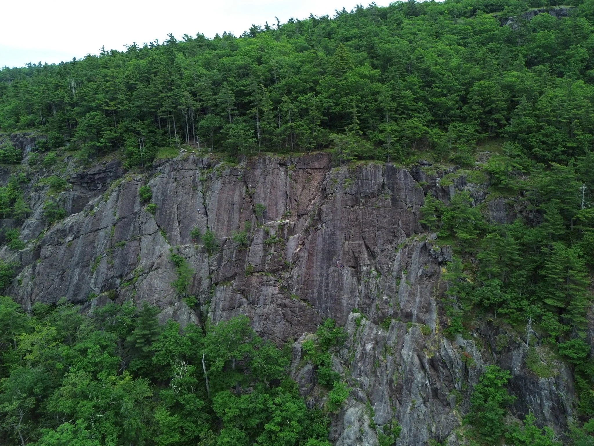 Barretts cove cliff with climbers ascending the roadside attraction.