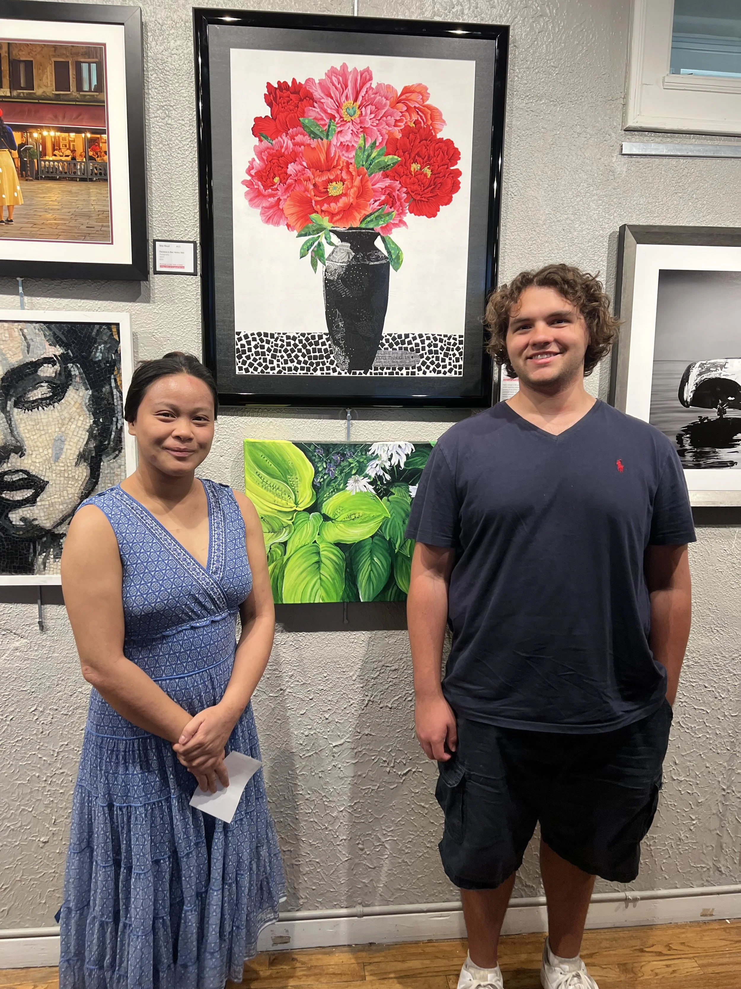 My son and his girlfriend flanking my peonies at a local art exhibit.