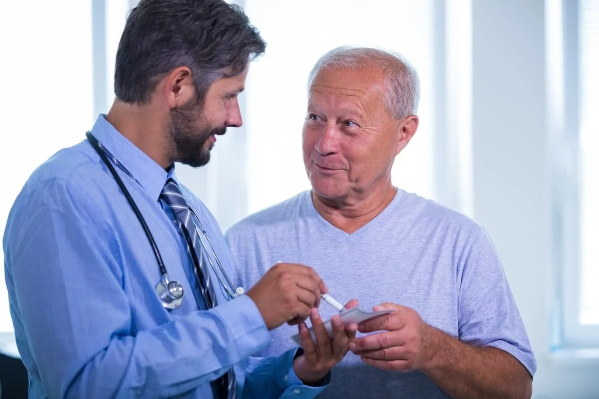 Man over 40 consulting with a medical provider about a supervised weight loss program