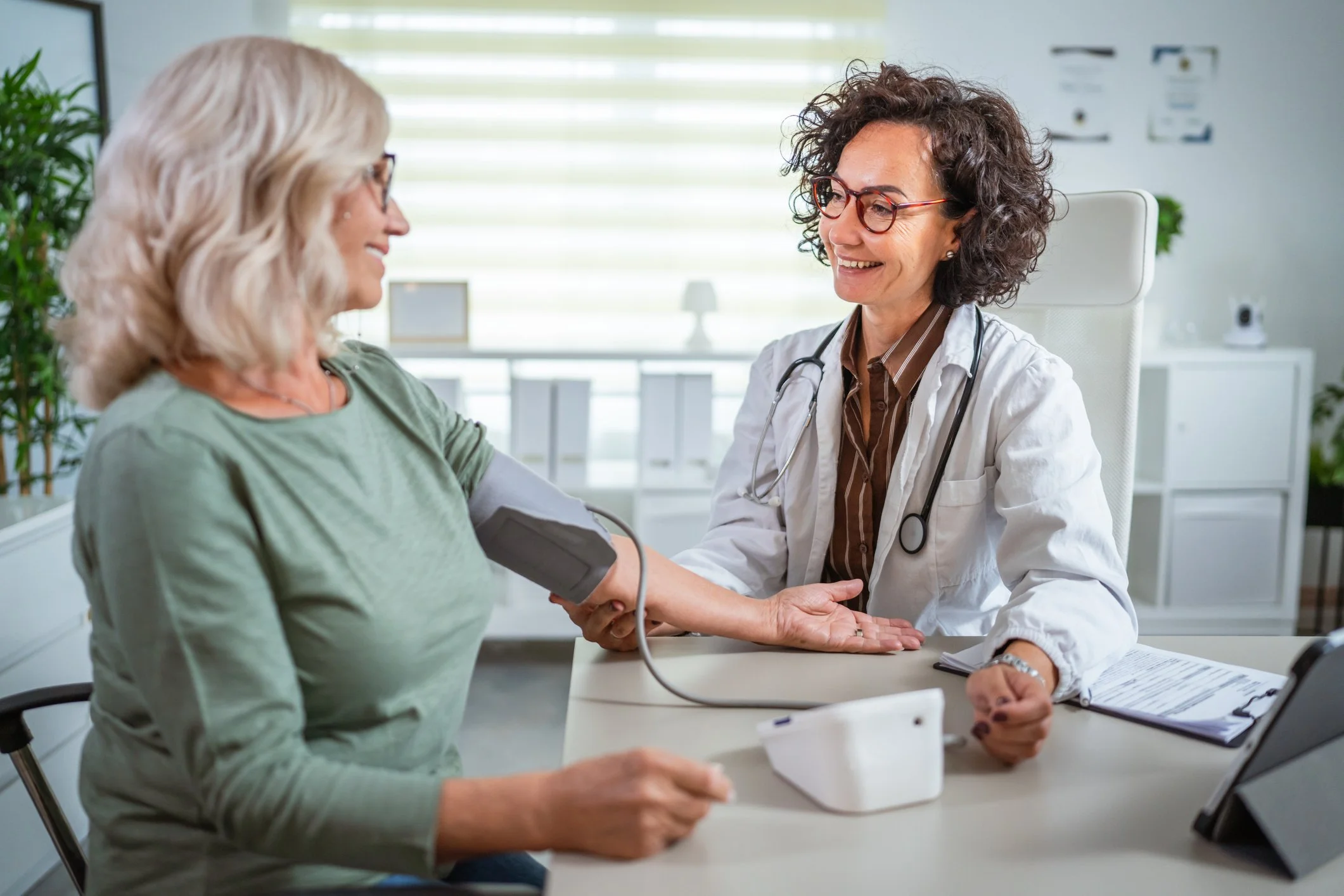 Healthcare provider checking a patient’s blood pressure as part of a medical evaluation for weight loss injections.