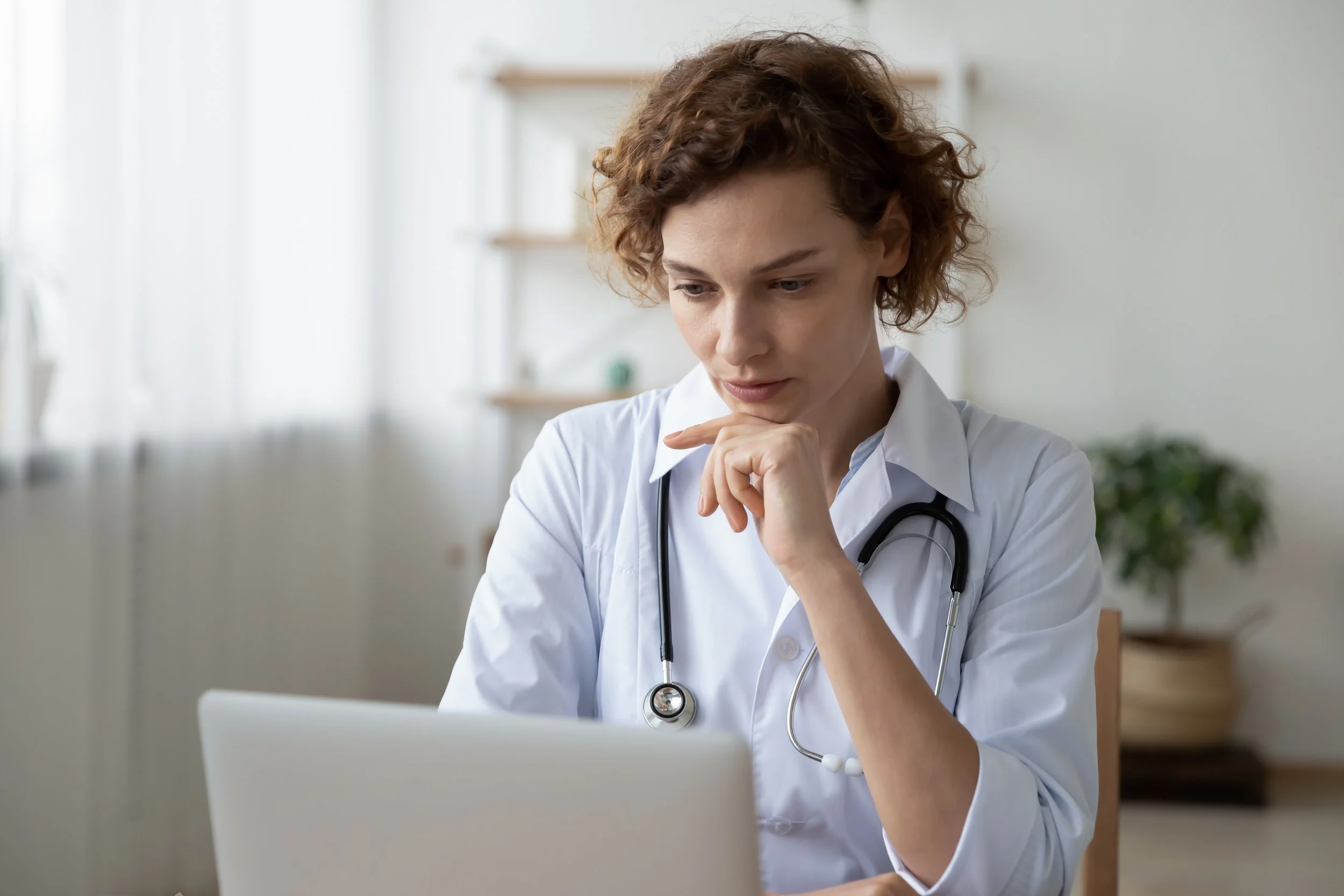 Licensed medical provider reviewing patient labs before recommending BPC-157 peptide therapy for weight loss